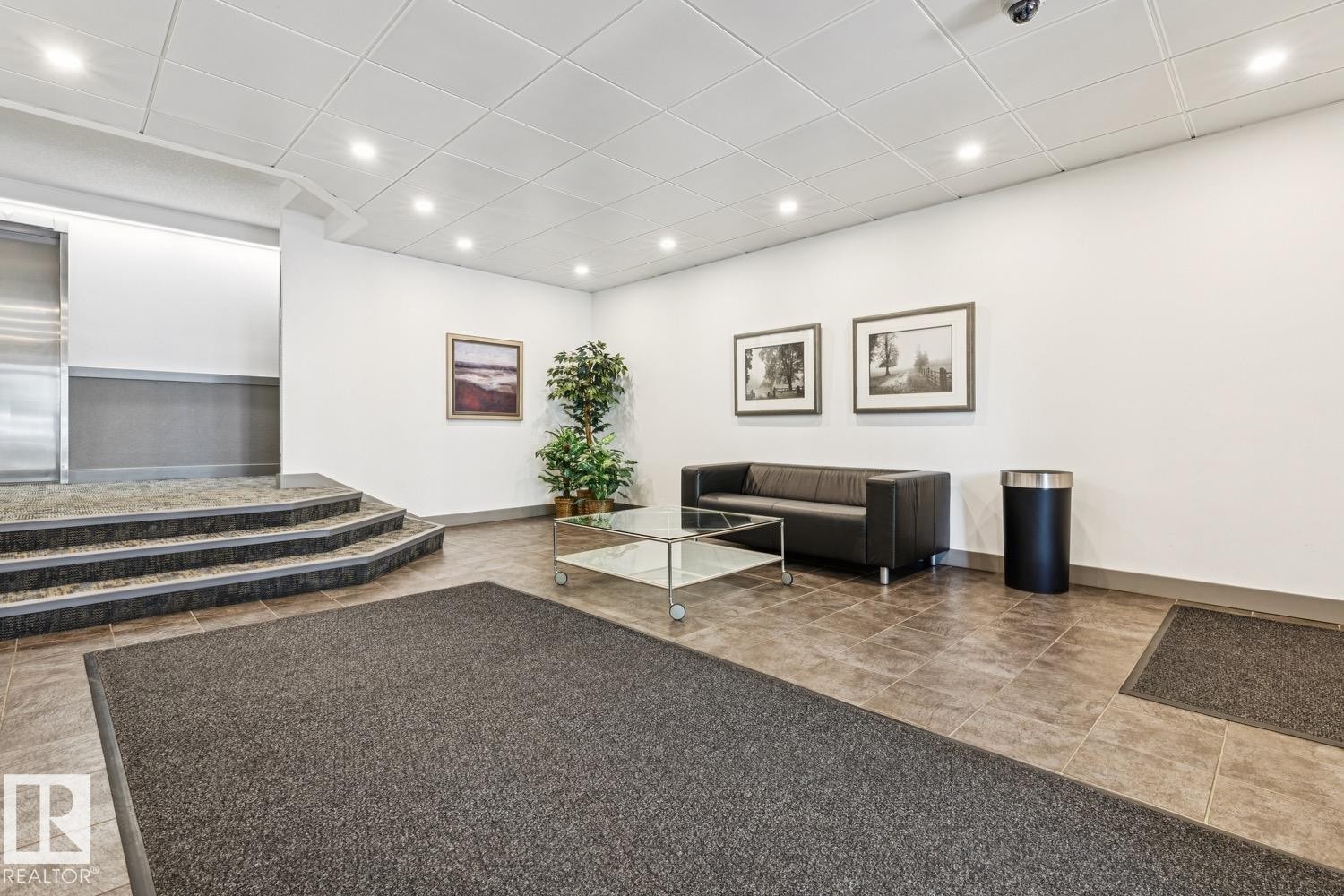 Recessed ceiling lighting illuminates the tiled flooring and white walls - #905 9929 113 St Nw, Edmonton, AB