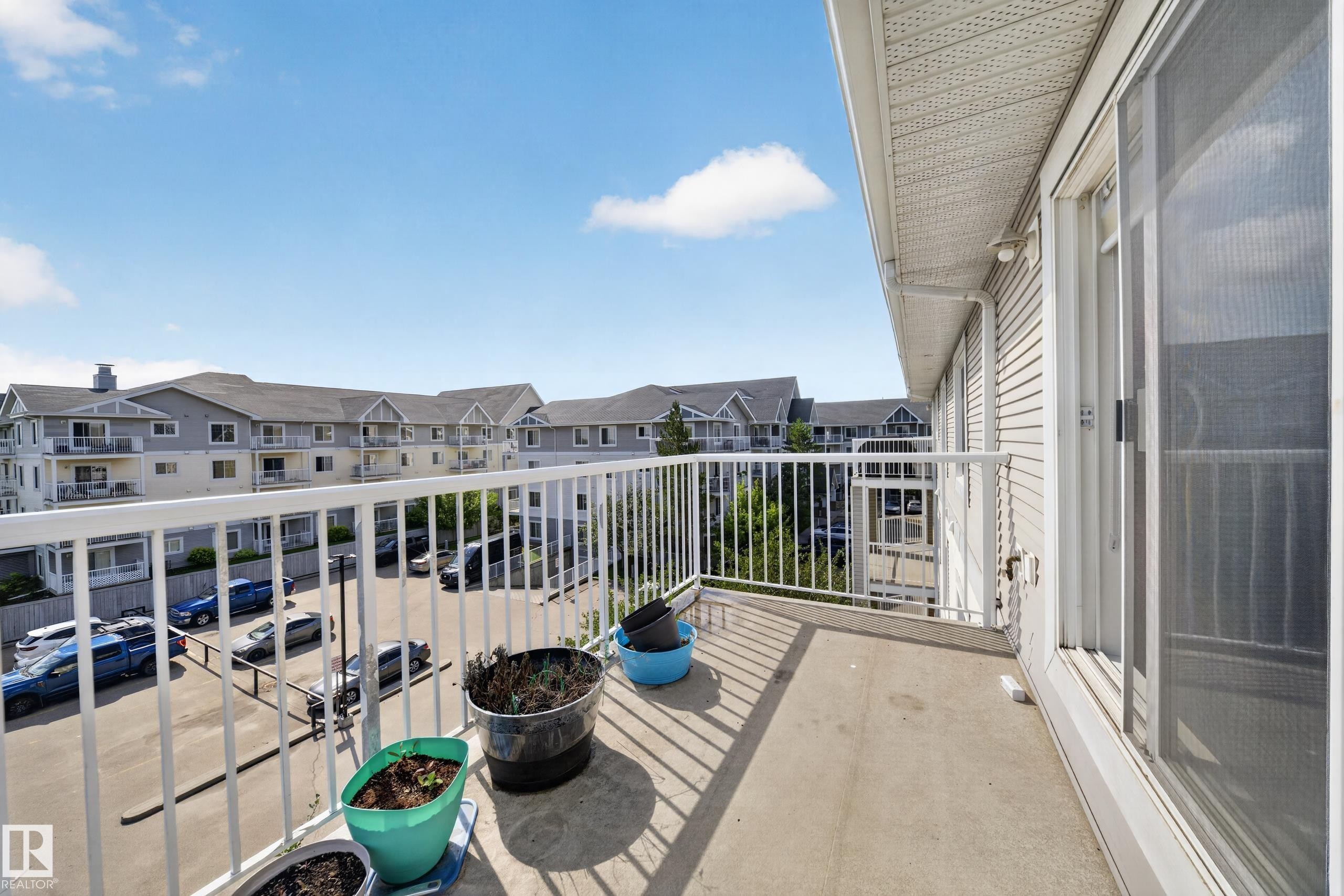 Private balcony featuring a concrete floor and white metal railing - #419 4407 23 St Nw, Edmonton, AB