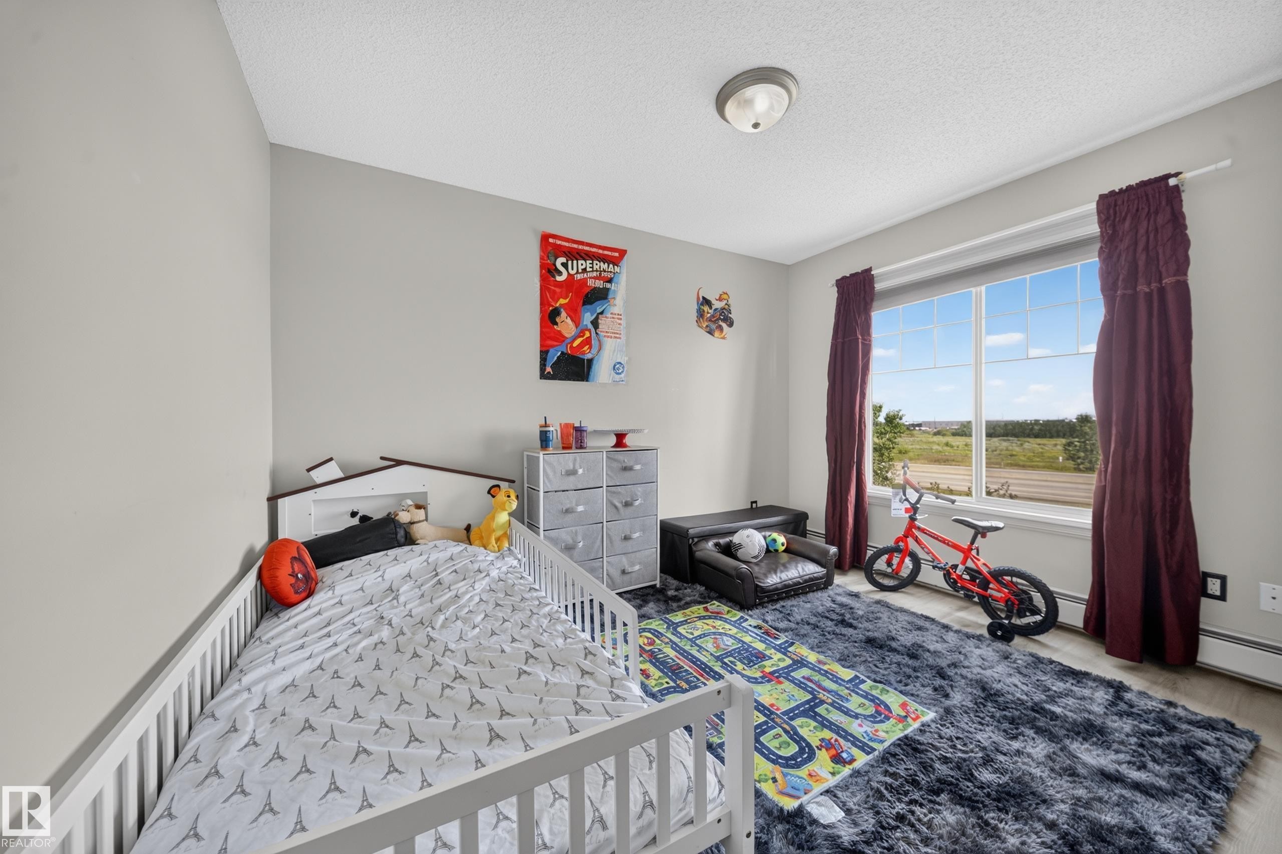 Large window with expansive outdoor scenery, neutral wall paint, and wood-finish flooring - #419 4407 23 St Nw, Edmonton, AB