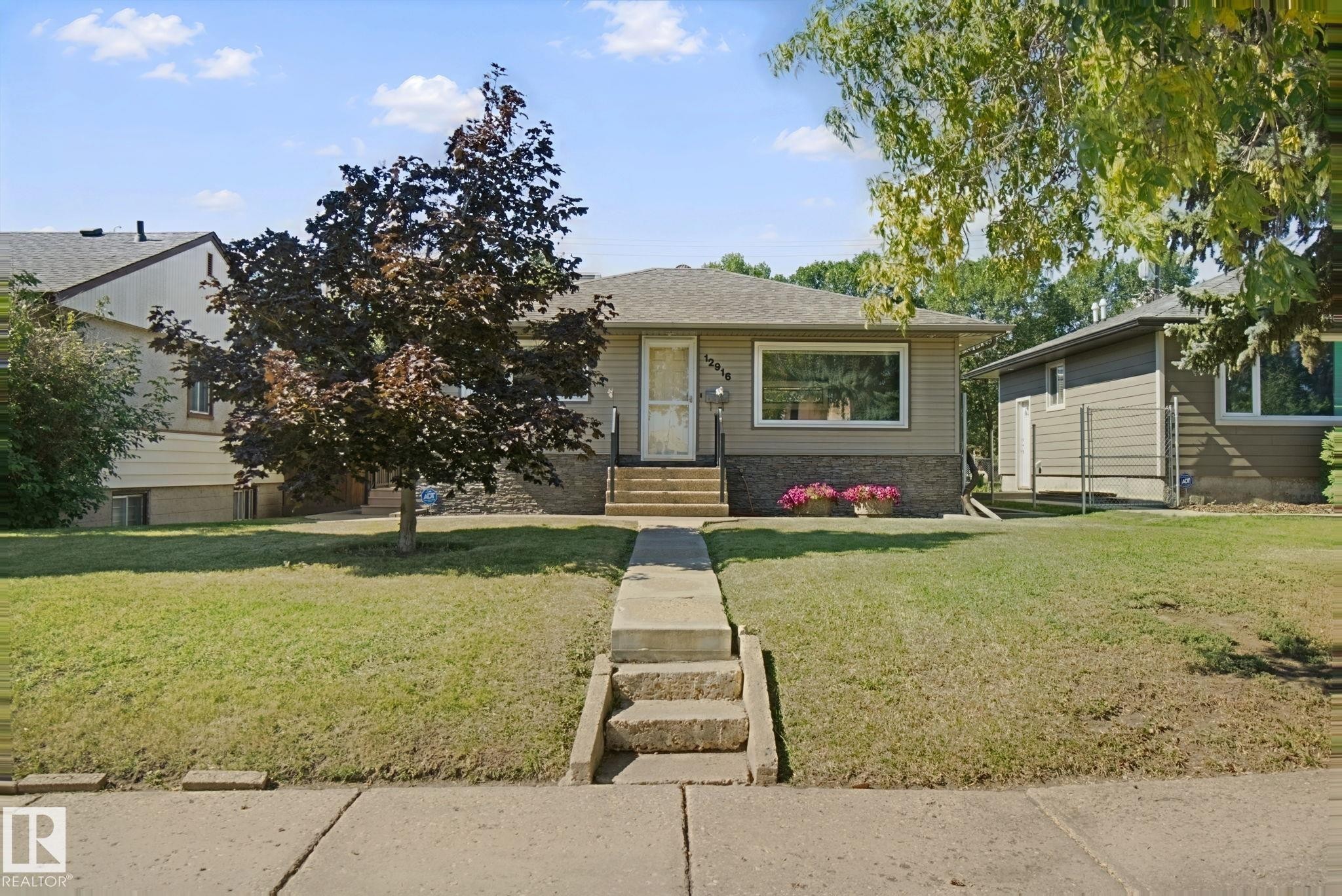 Single-story exterior with light-colored siding - 12916 63 Street Nw, Edmonton, AB