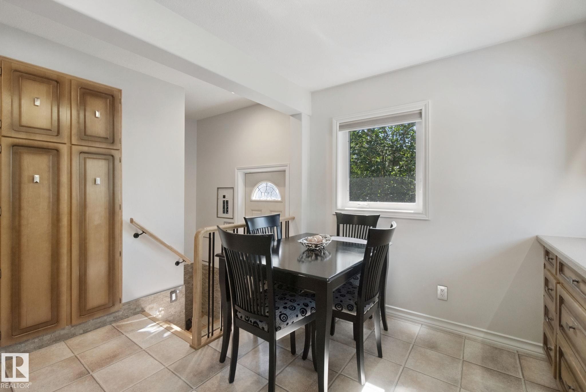 Built-in cabinetry, ceramic tile flooring, and a large window providing natural illumination - 12916 63 Street Nw, Edmonton, AB