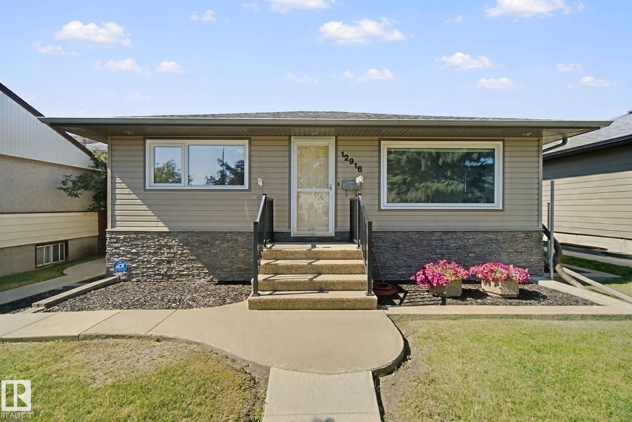 Horizontal siding exterior with stone accent detailing - 12916 63 Street Nw, Edmonton, AB