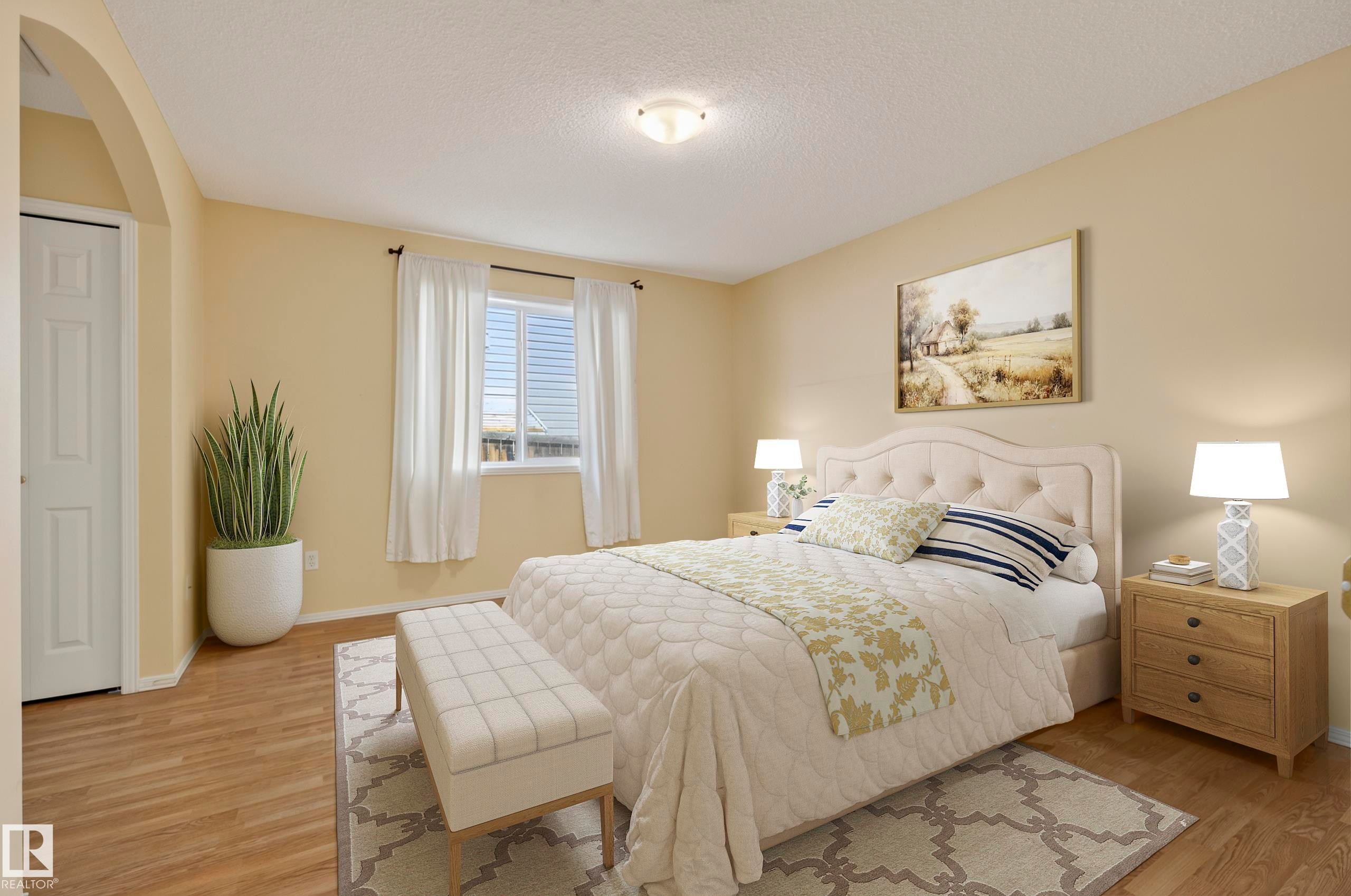 Wood-finish flooring, recessed lighting, arched doorway, window with blinds, and neutral wall paint - 15213 49A Street Nw, Edmonton, AB