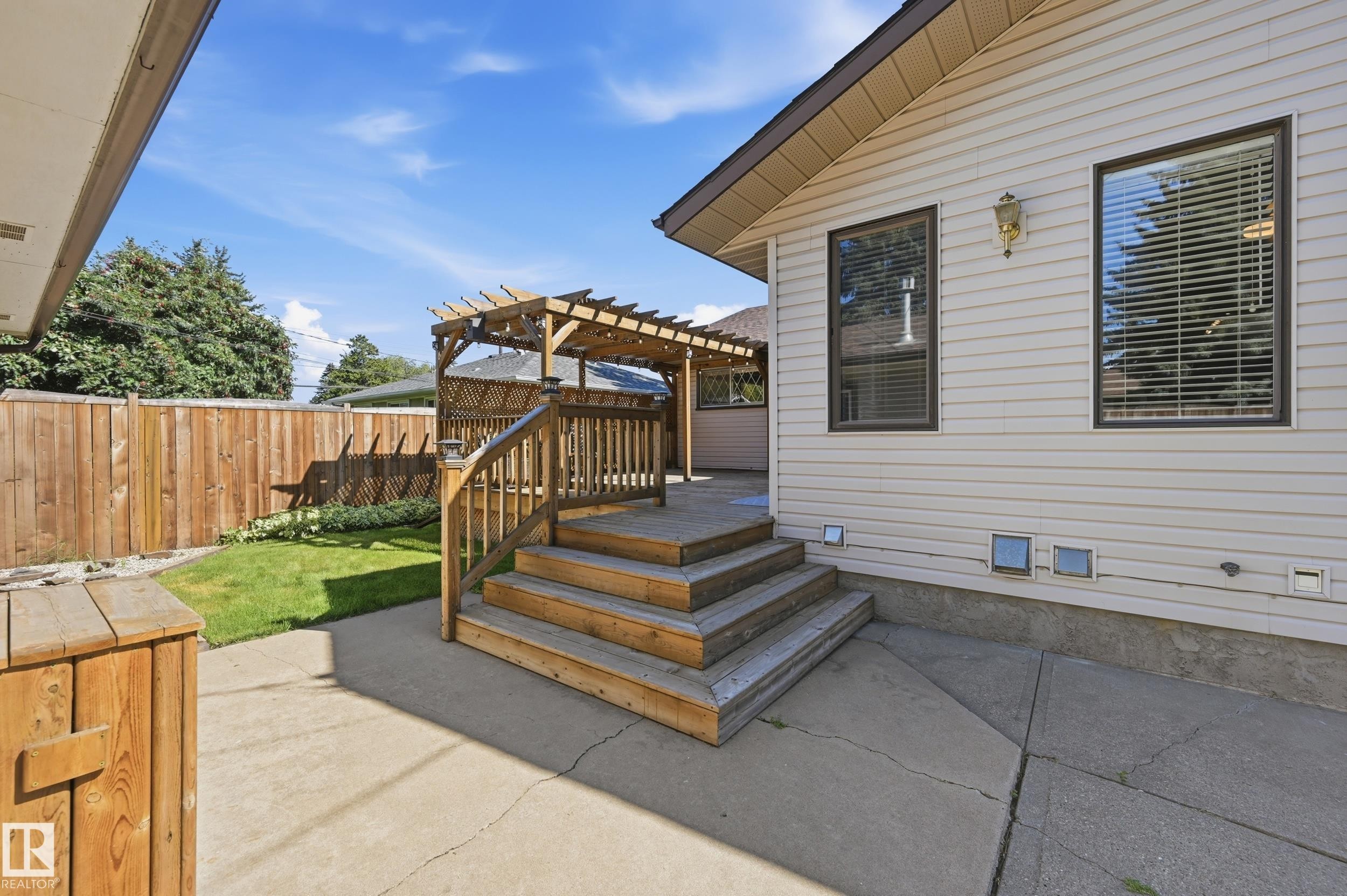 Wood deck with pergola, stairs, and railings - 10552 45 Street Nw, Edmonton, AB