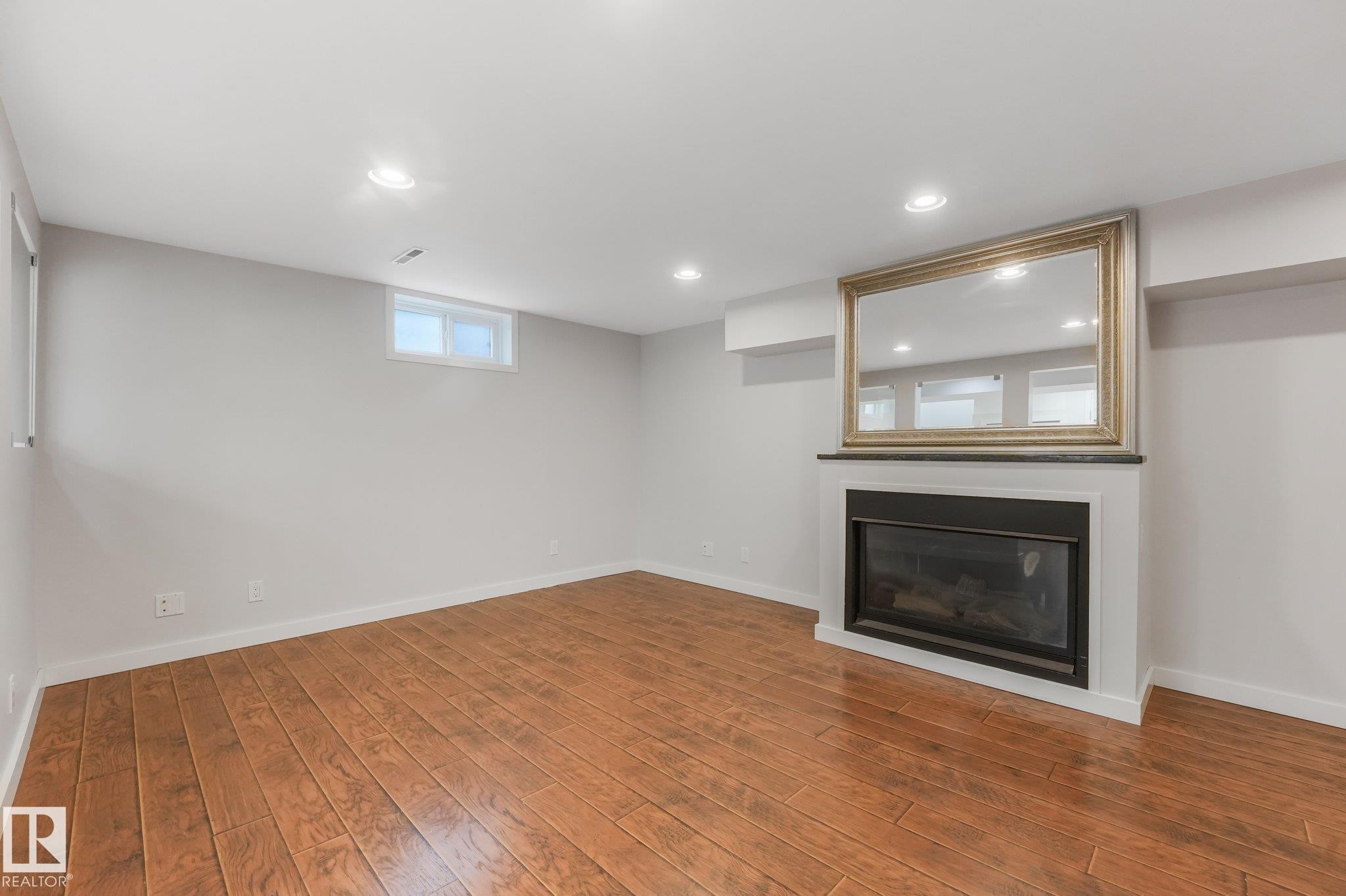 4812 Malmo Road Nw, Edmonton, AB - Indoor Photo Showing Other Room With Fireplace