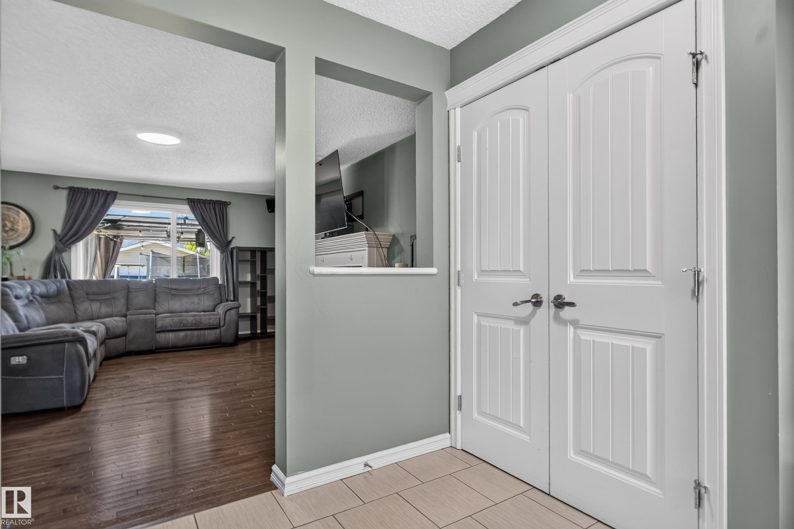 Panel-style double doors, wood-finish flooring, and recessed ceiling lighting - 1332 72 Street Sw, Edmonton, AB