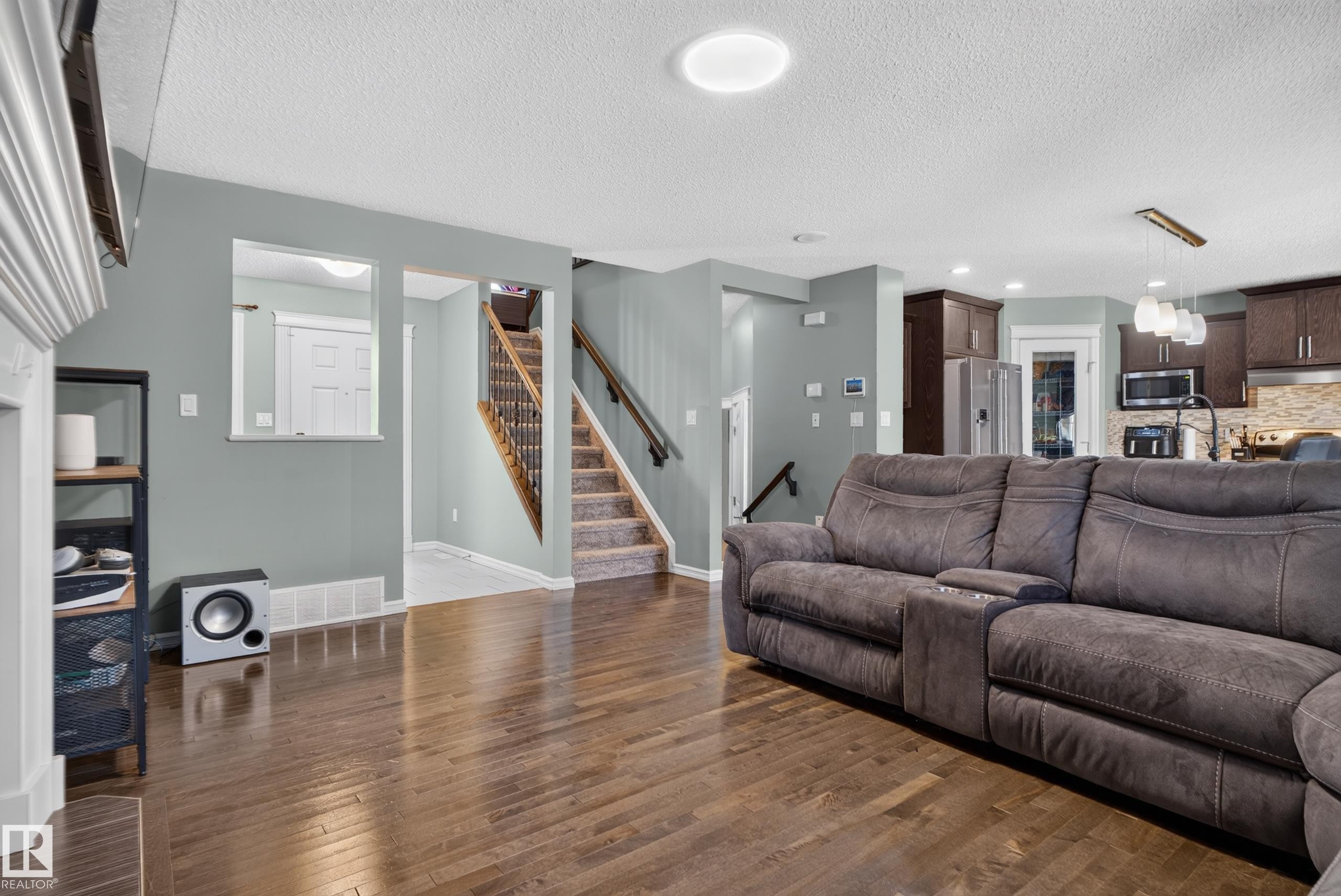 Wood-finish flooring throughout main living area - 1332 72 Street Sw, Edmonton, AB