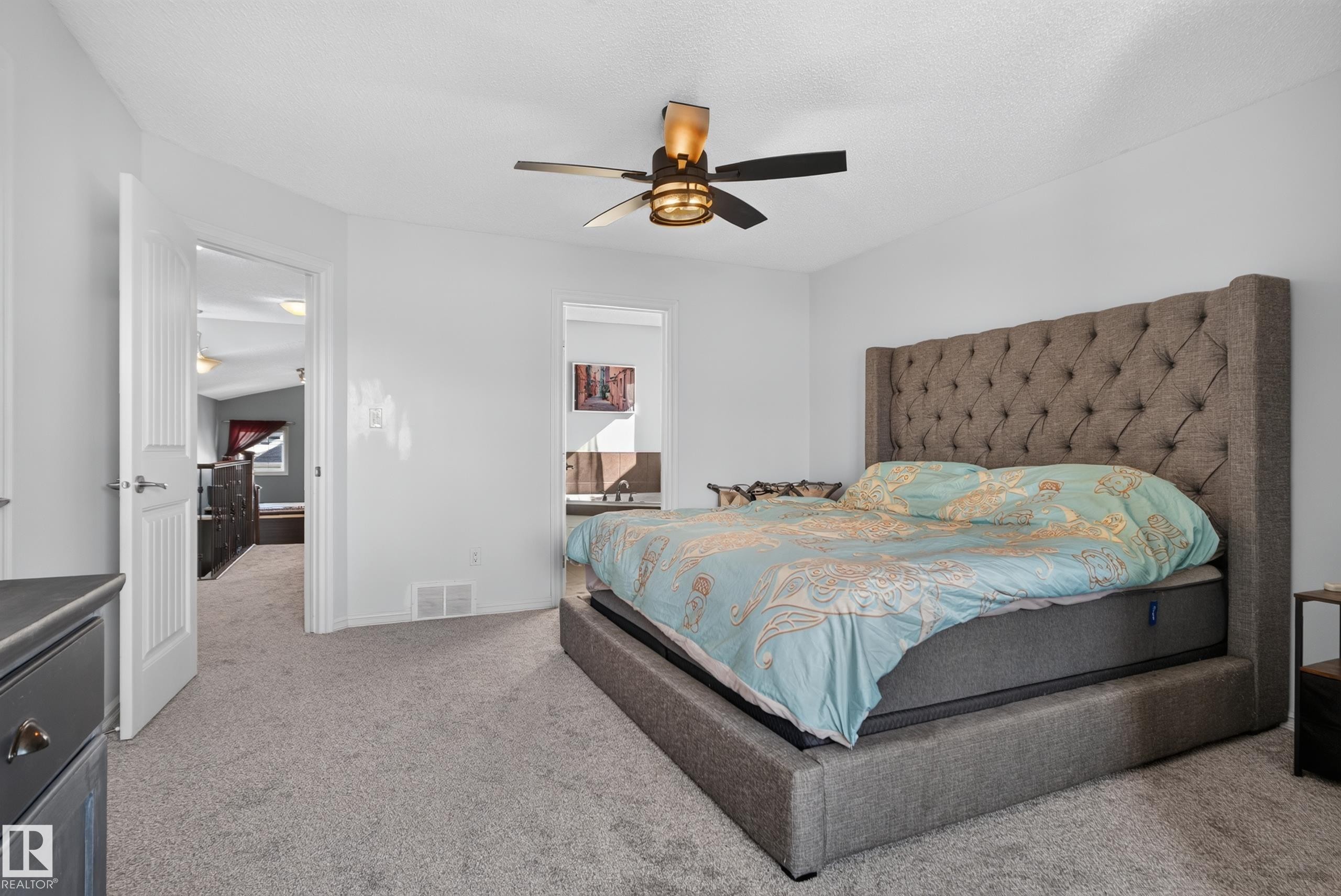 Recessed lighting with a ceiling fan, carpet flooring, and a doorway to an additional room - 1332 72 Street Sw, Edmonton, AB