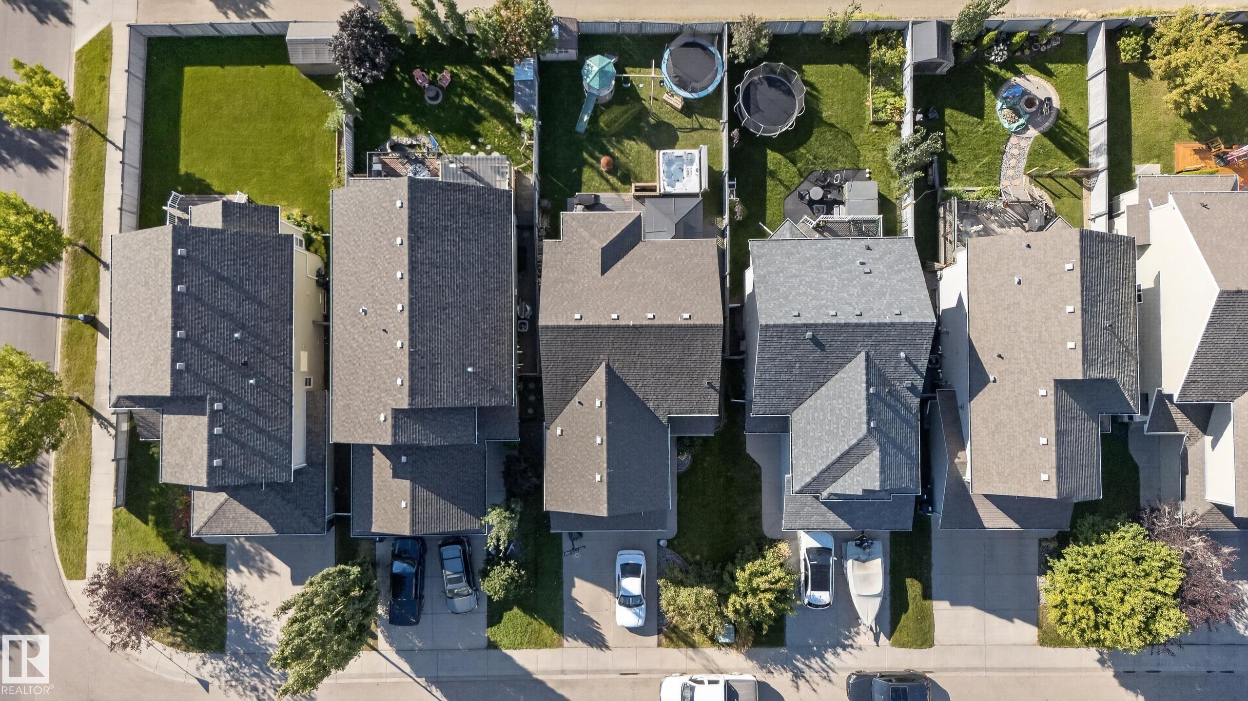 Asphalt shingle roofing, paved driveways, private fenced backyards, and mature street trees - 1332 72 Street Sw, Edmonton, AB