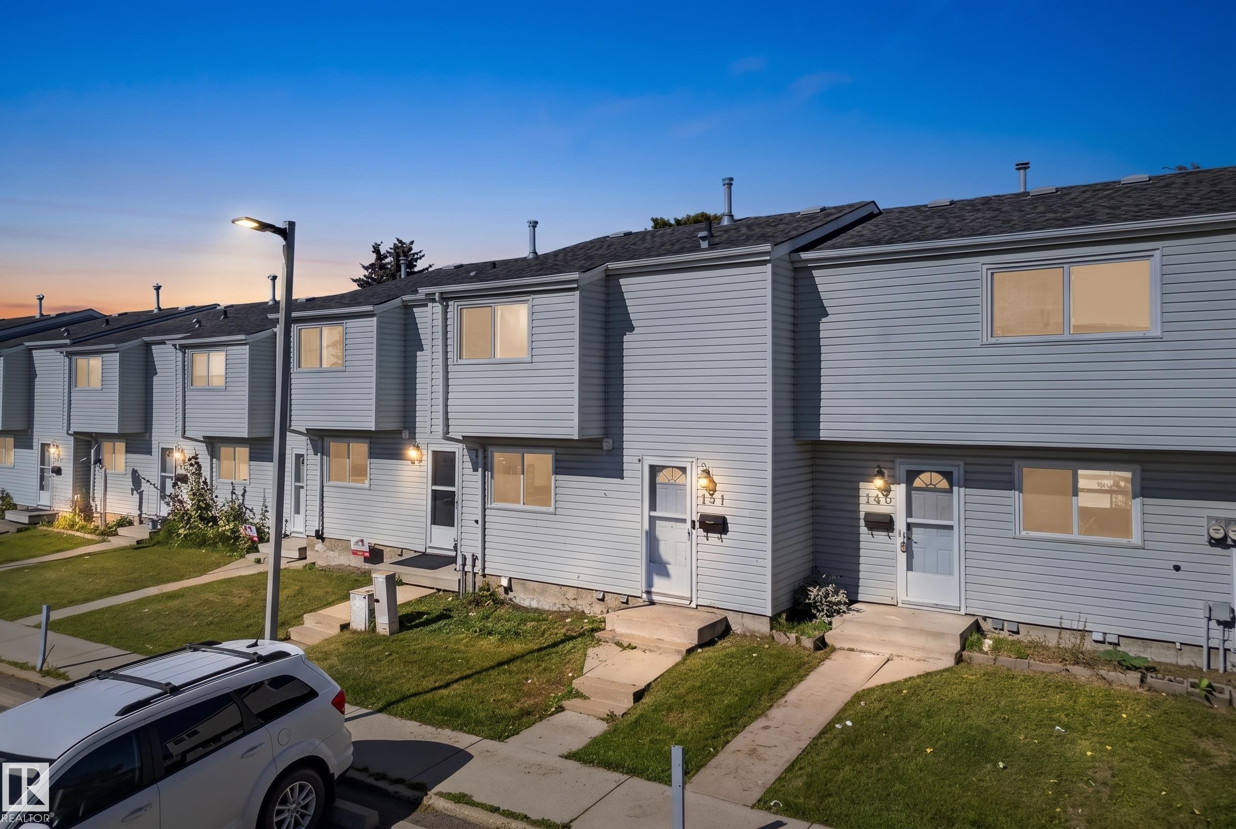 Siding exterior with multiple windows and front entryways - 141 Dickinsfield Court Nw, Edmonton, AB