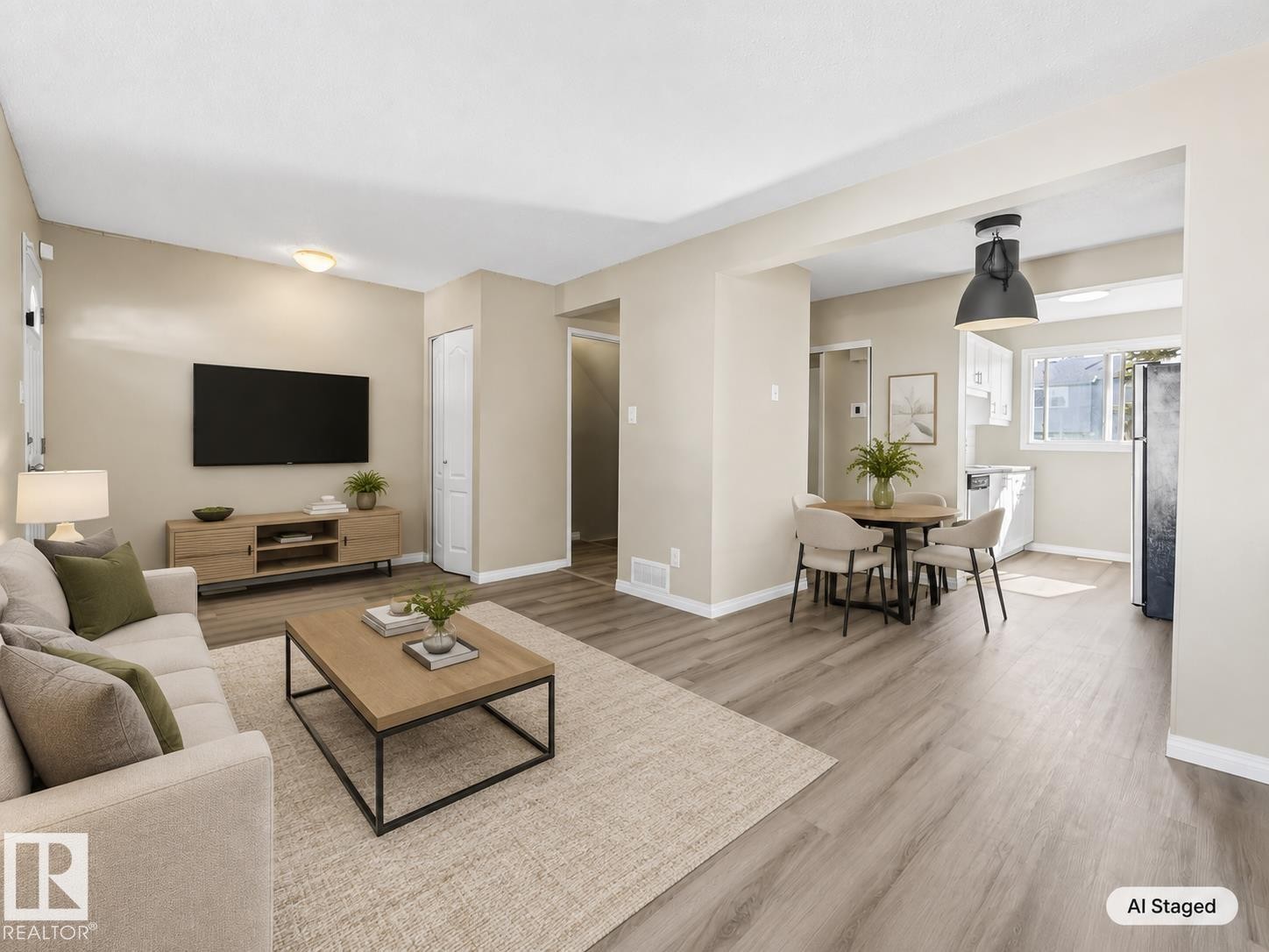 Open-concept living area with wood-finish flooring, recessed lighting, and a white bi-fold closet door - 141 Dickinsfield Court Nw, Edmonton, AB