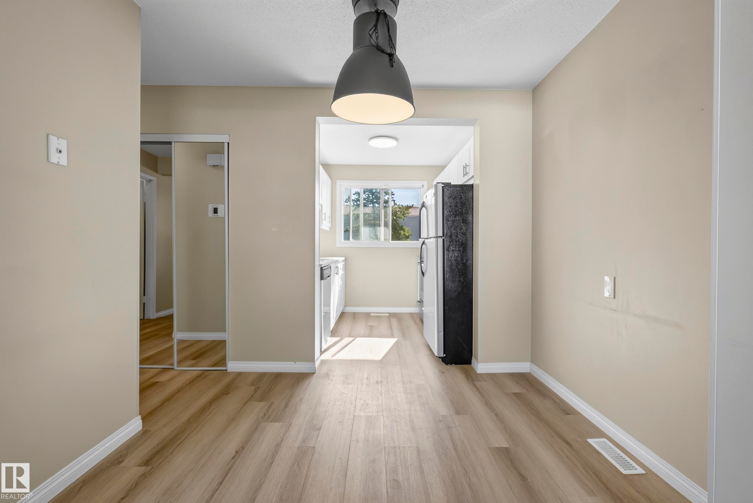 Wood-finish flooring throughout, neutral wall tones, and recessed lighting - 141 Dickinsfield Court Nw, Edmonton, AB