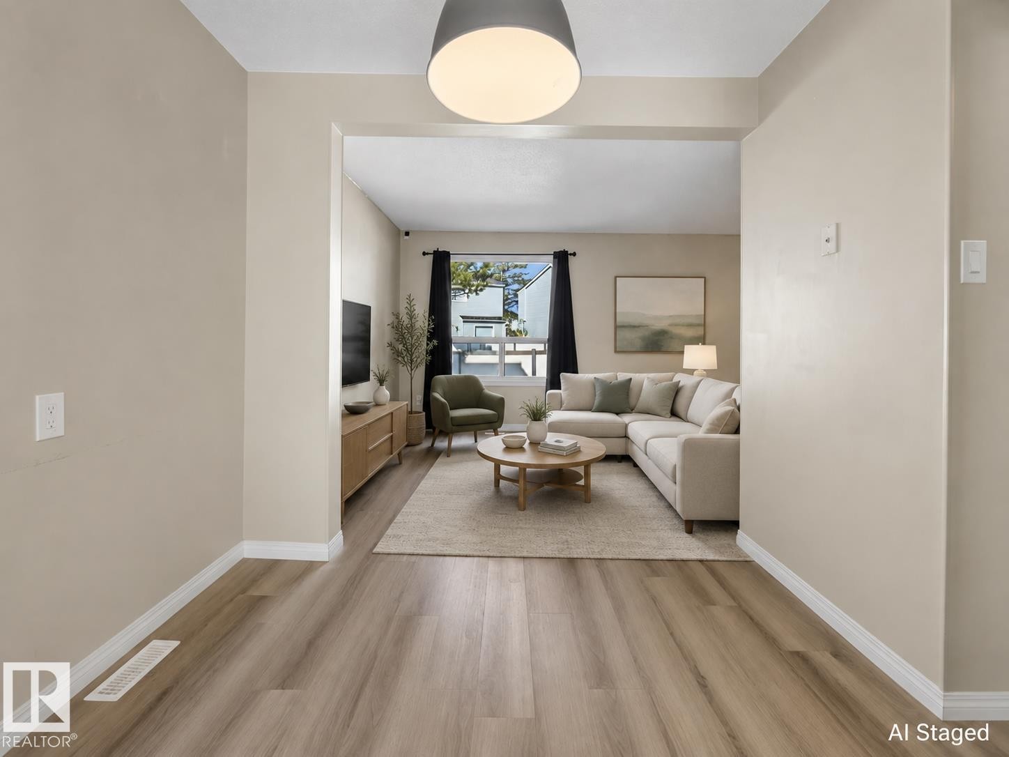 Open-concept living area with wood-finish flooring, neutral wall tones, and a large window - 141 Dickinsfield Court Nw, Edmonton, AB
