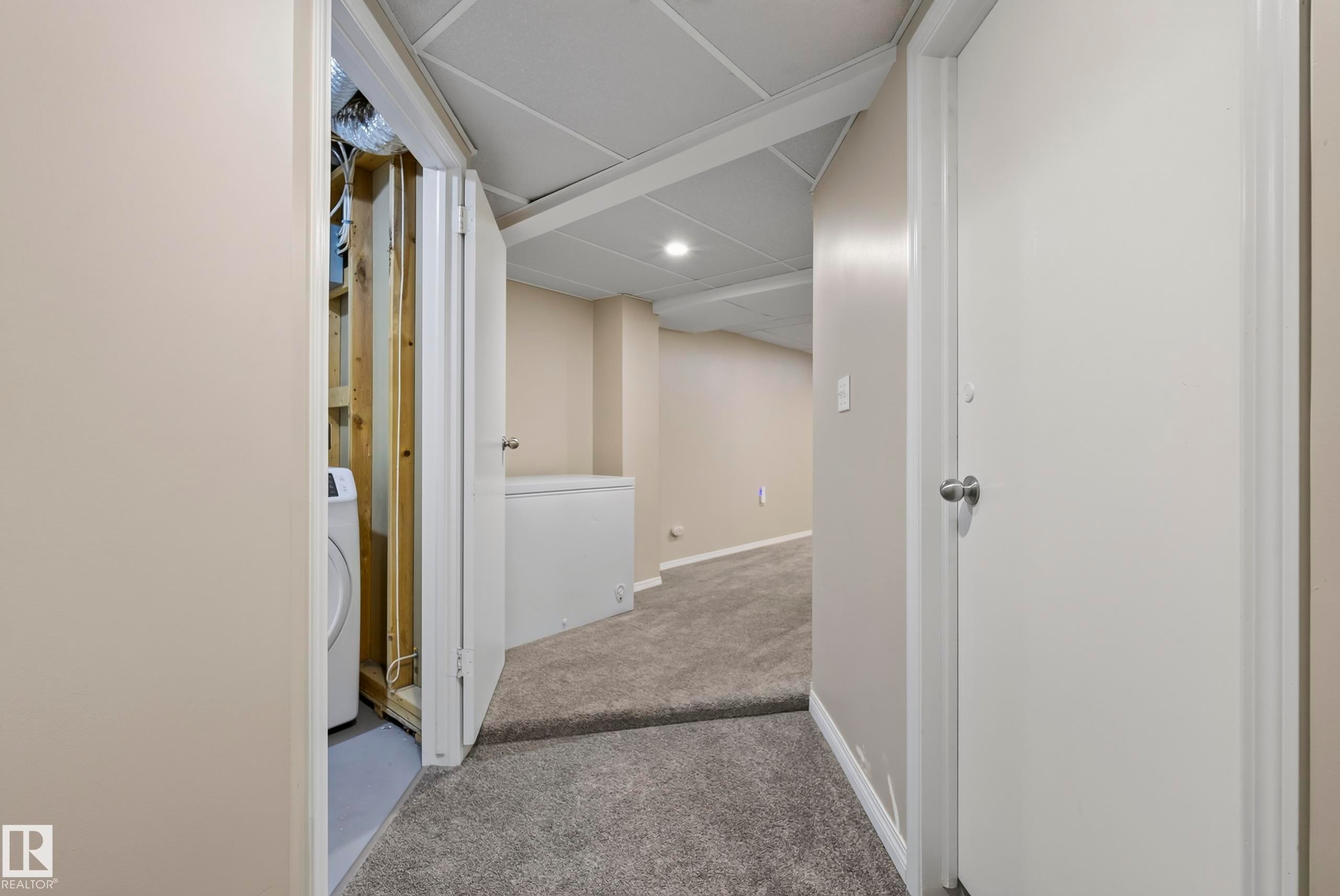 Neutral wall paint, drop ceiling with recessed lighting, and grey carpeted flooring - 141 Dickinsfield Court Nw, Edmonton, AB