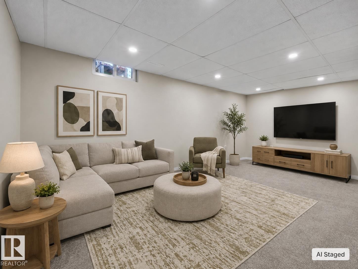 Recessed lighting illuminates this versatile living space featuring a drop ceiling, neutral wall tones, and soft carpet flooring - 141 Dickinsfield Court Nw, Edmonton, AB