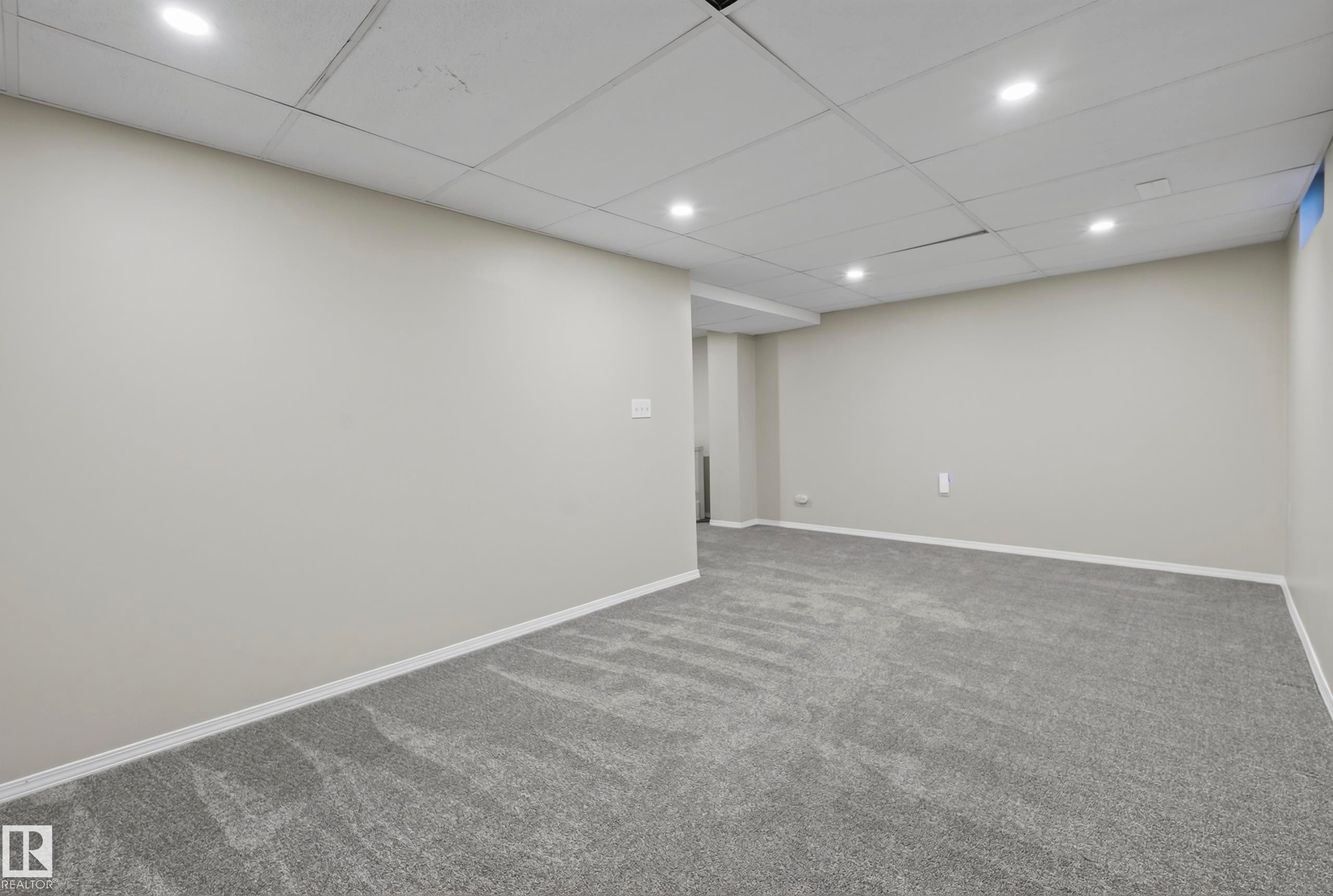 Recessed lighting, gray carpeting, neutral wall paint, white trim, acoustical tile ceiling - 141 Dickinsfield Court Nw, Edmonton, AB