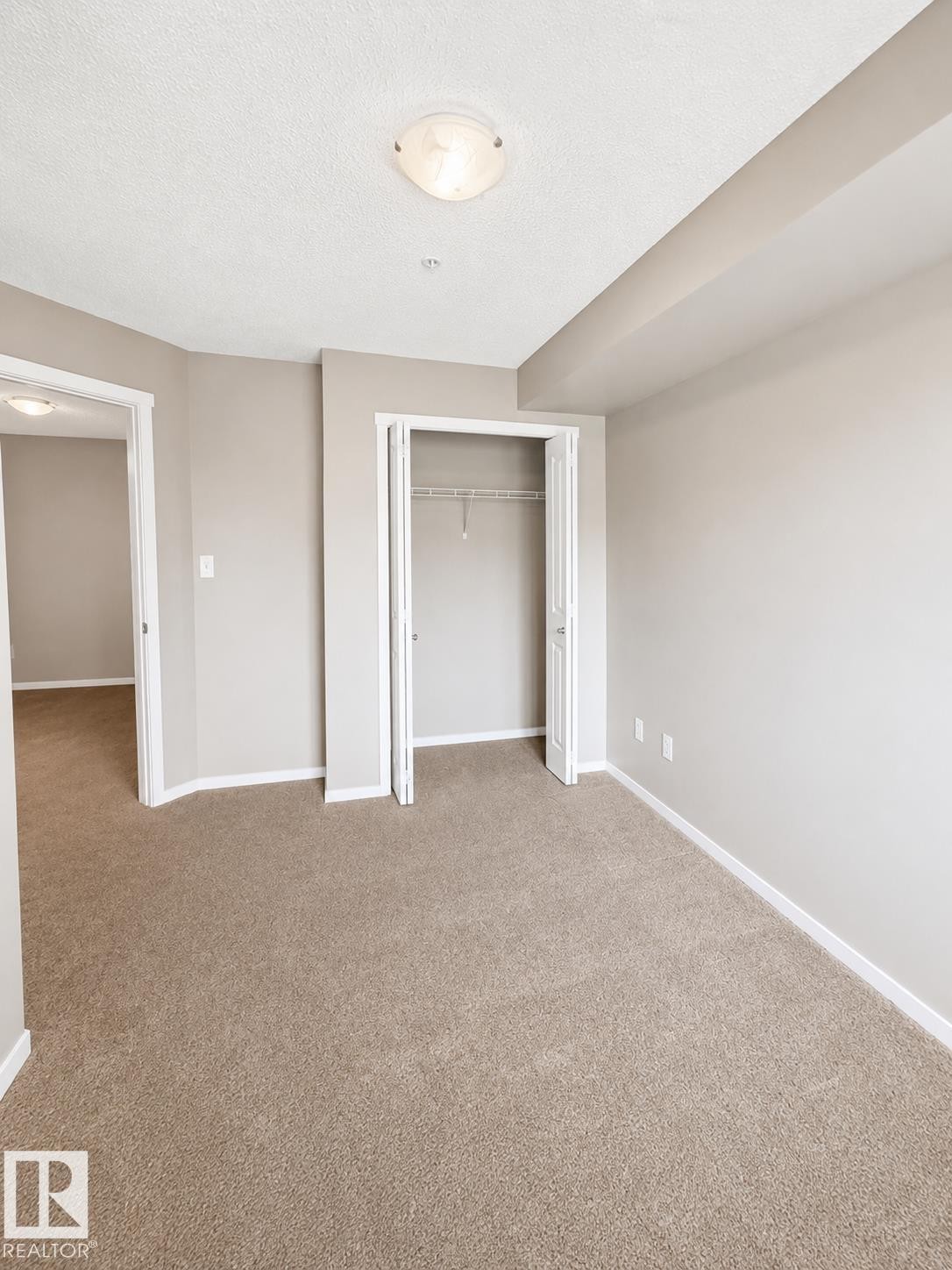 Neutral-toned carpeting throughout - #208 18122 77 St Nw, Edmonton, AB