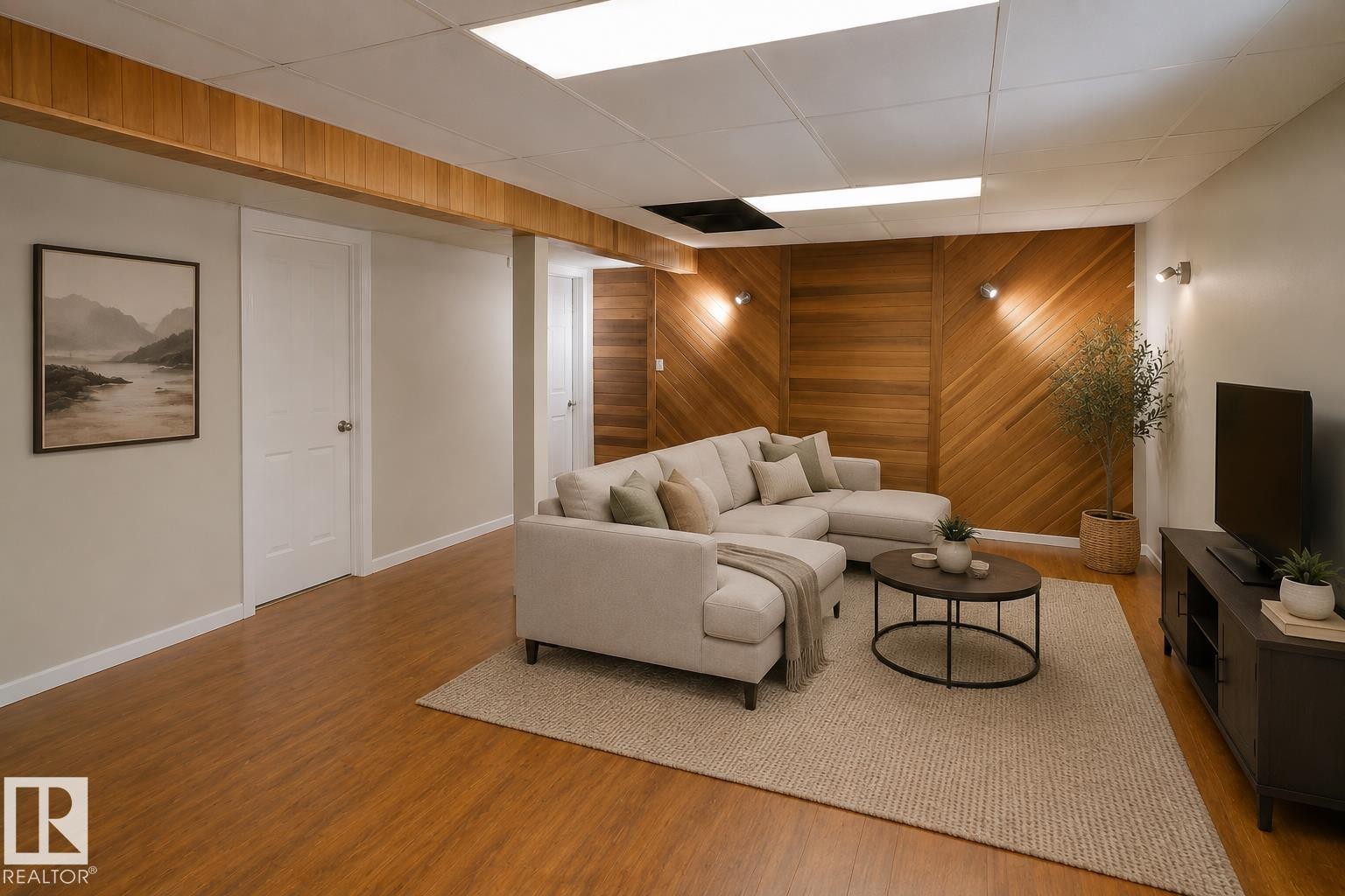 Wood-finish flooring, wood plank accent wall, recessed lighting, and wall-mounted sconces - 10439 36A Ave Nw, Edmonton, AB