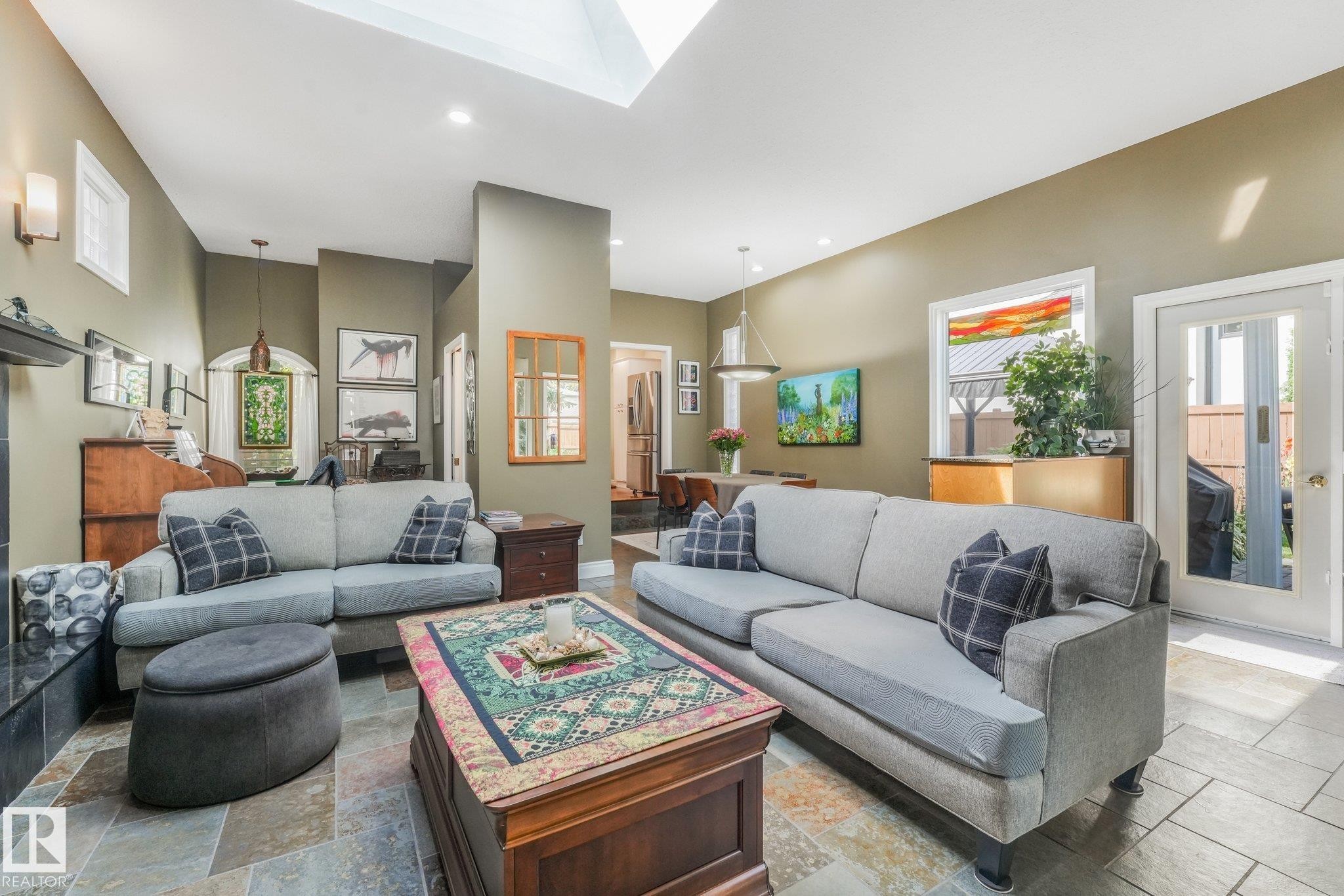 Skylight with recessed lighting, Brazilian slate flooring, wall sconces, a glass-paneled exterior door. - 10531 137 Street Nw, Edmonton, AB