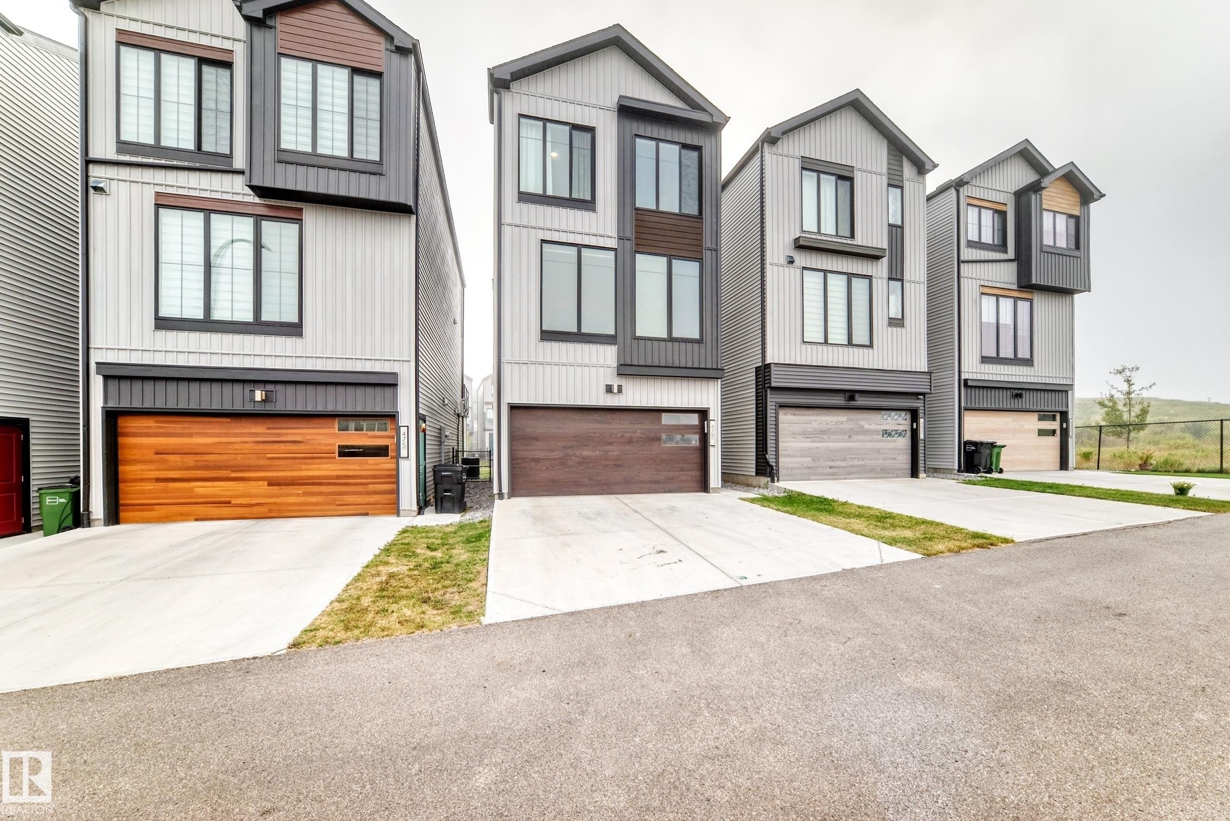 Modern architectural design featuring vertical siding and dark trim accents - 479 39 St Sw, Edmonton, AB