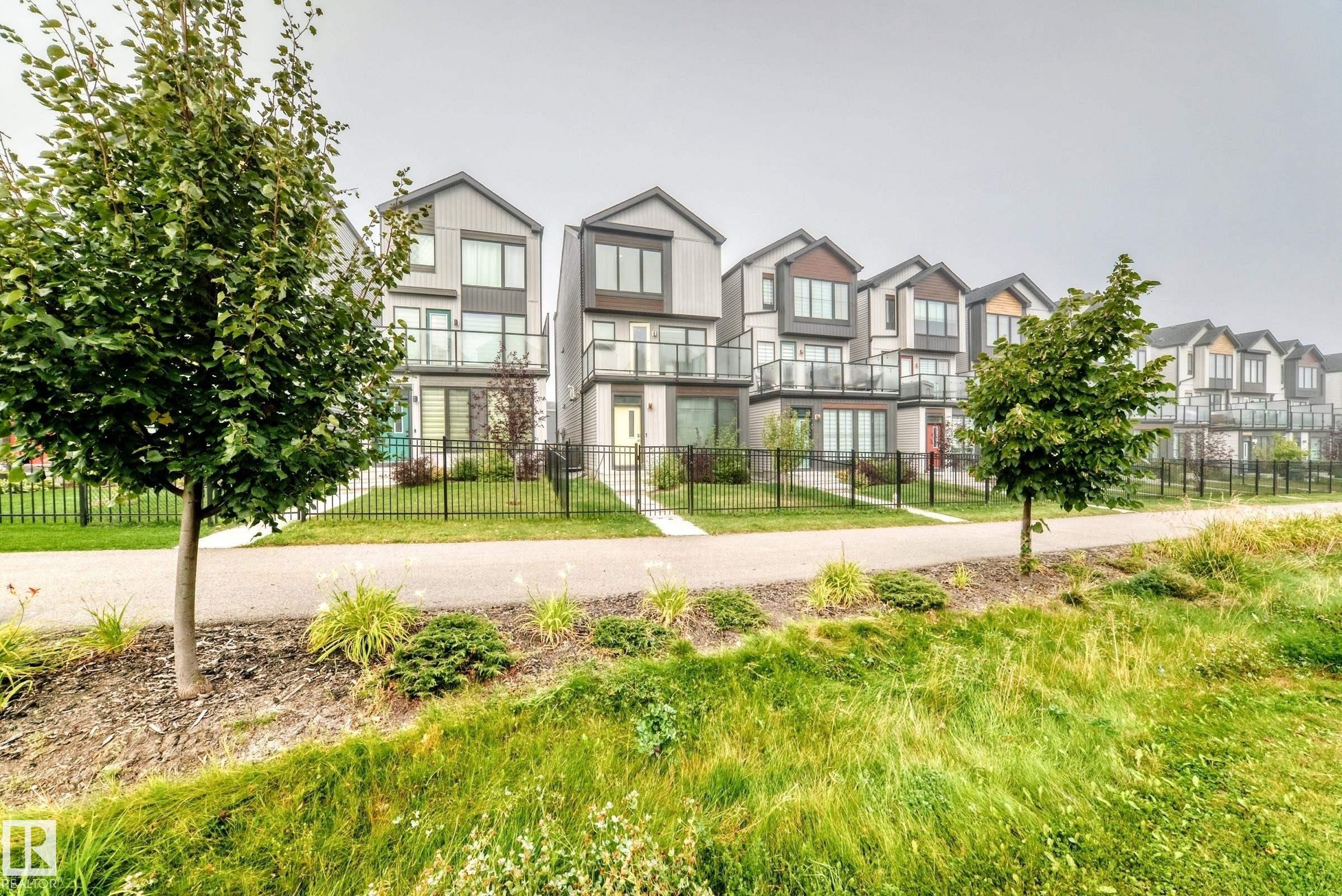 Modern exterior architecture with multiple balconies and integrated landscaping - 479 39 St Sw, Edmonton, AB