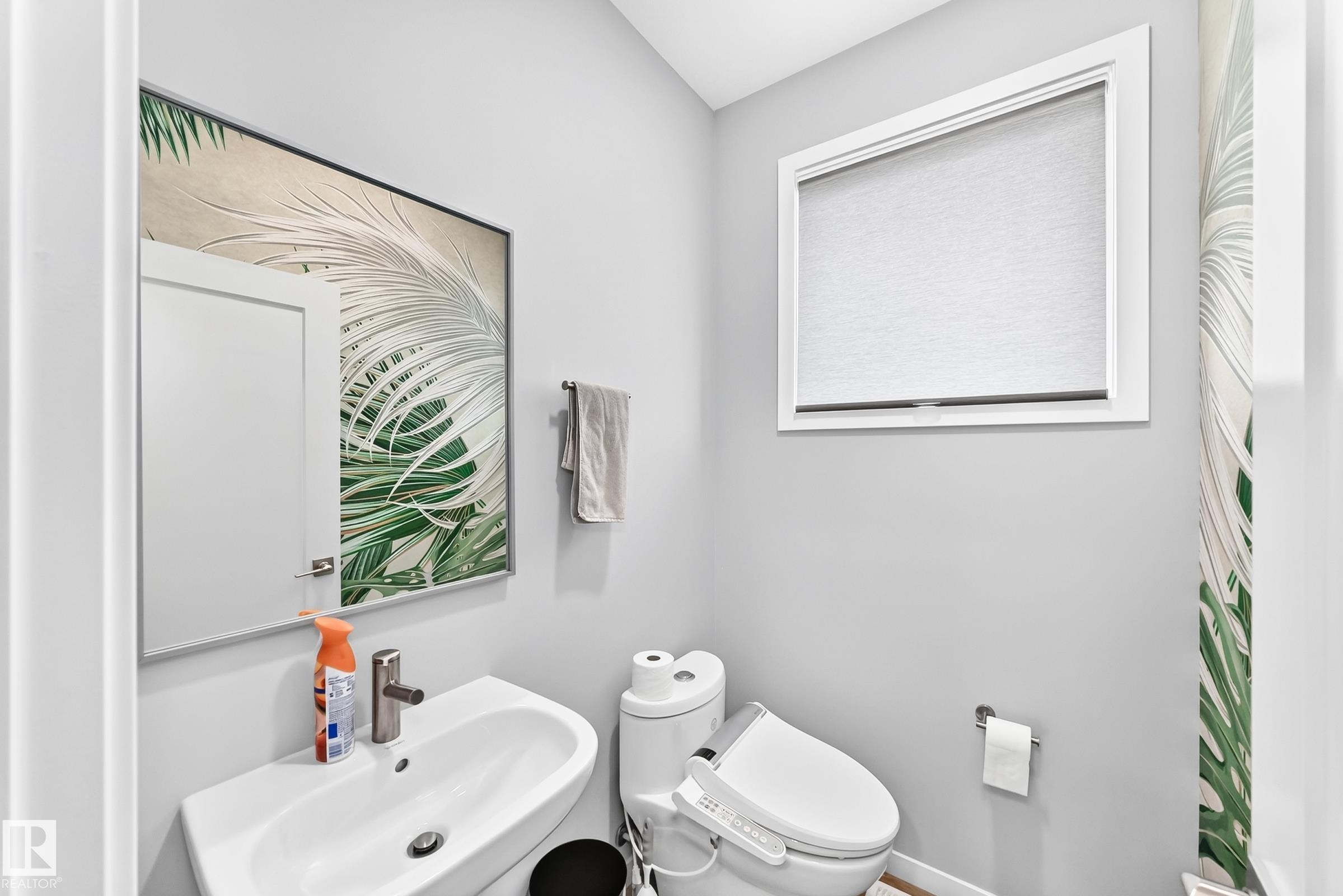 Modern wall-mounted sink with a polished chrome faucet - 479 39 St Sw, Edmonton, AB