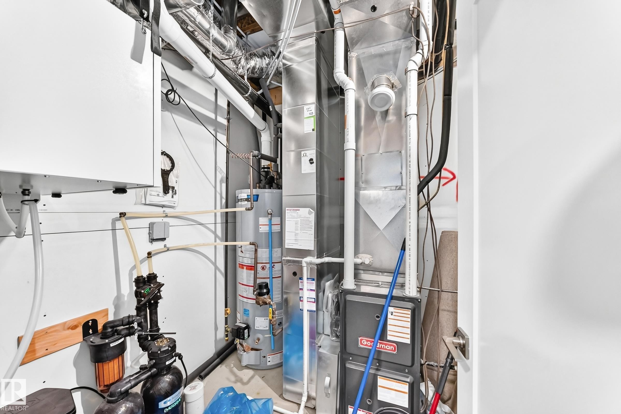 Utility area featuring a water heater, furnace, and water filtration system - 479 39 St Sw, Edmonton, AB