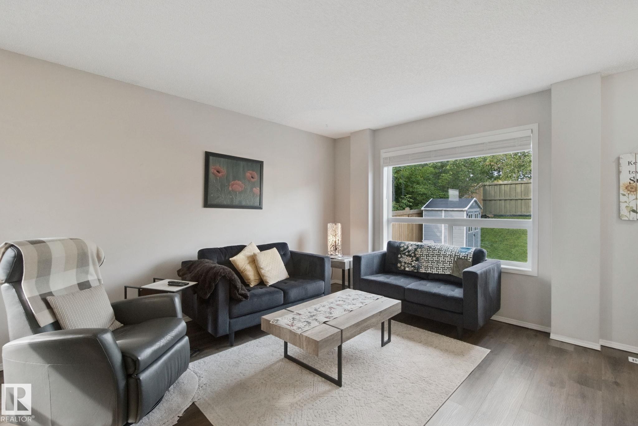 Wood-finish flooring throughout, complemented by light-toned wall finishes - 15618 141 Street Nw, Edmonton, AB