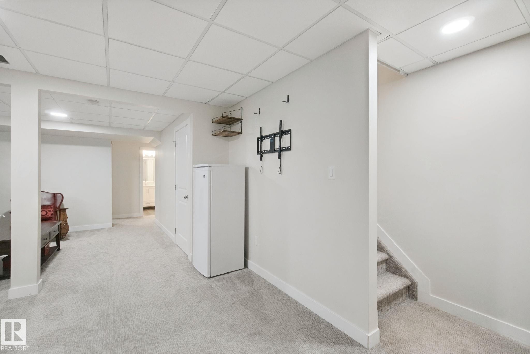 Carpeted flooring, drop ceiling, recessed lighting, and a white interior door - 15618 141 Street Nw, Edmonton, AB