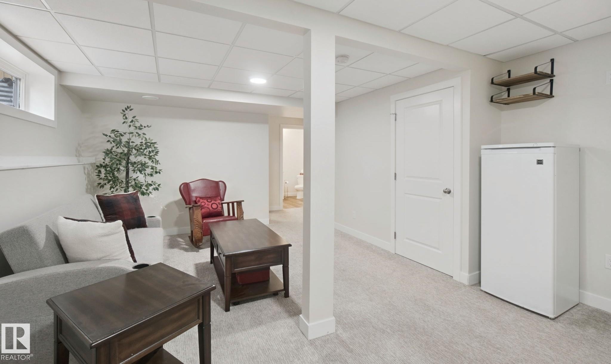 Recessed lighting, light-toned carpeting, a built-in window, a solid panel interior door, and wall-mounted shelving - 15618 141 Street Nw, Edmonton, AB