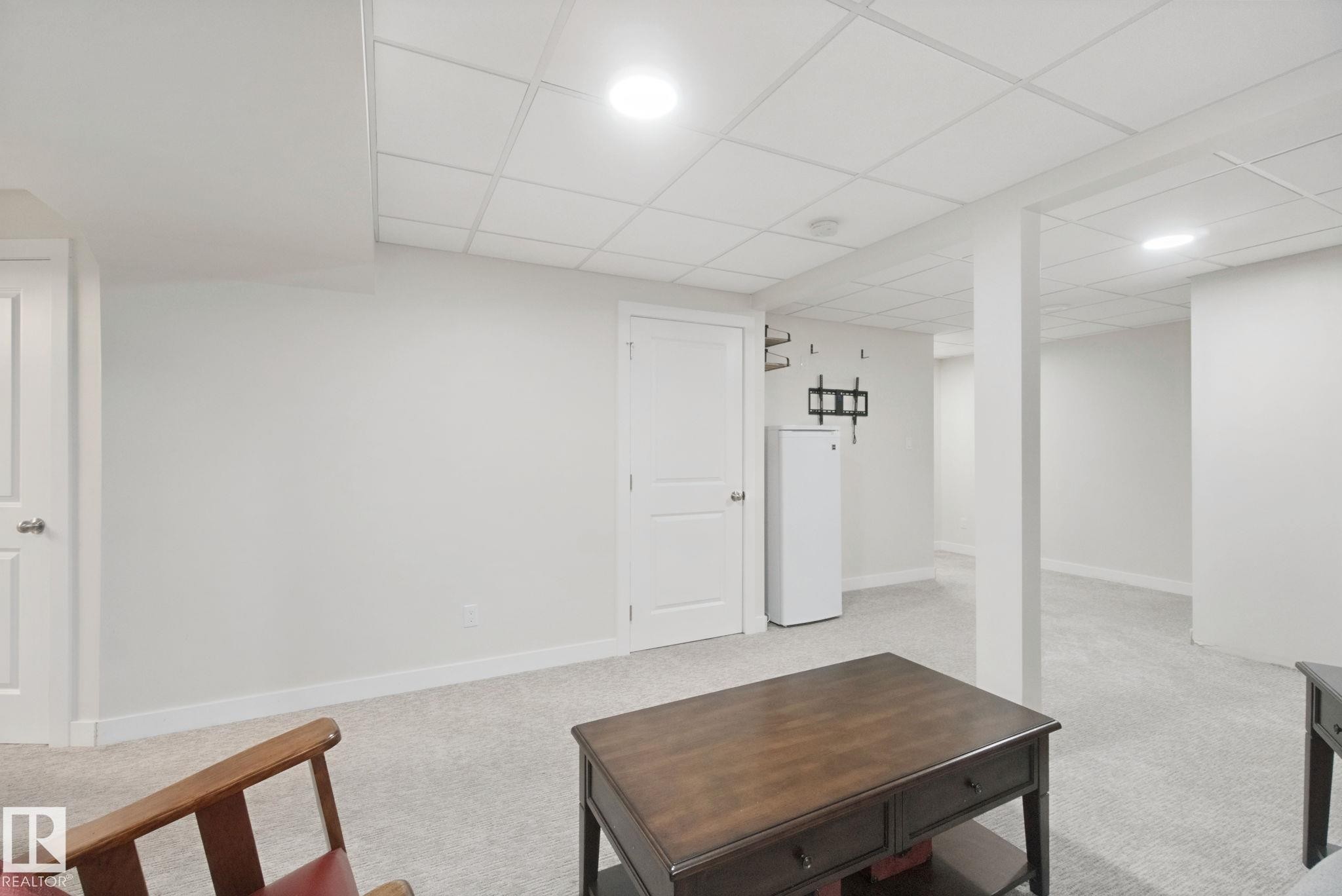 Spacious finished basement with neutral drywall, recessed ceiling lighting, and light-colored concrete flooring - 15618 141 Street Nw, Edmonton, AB