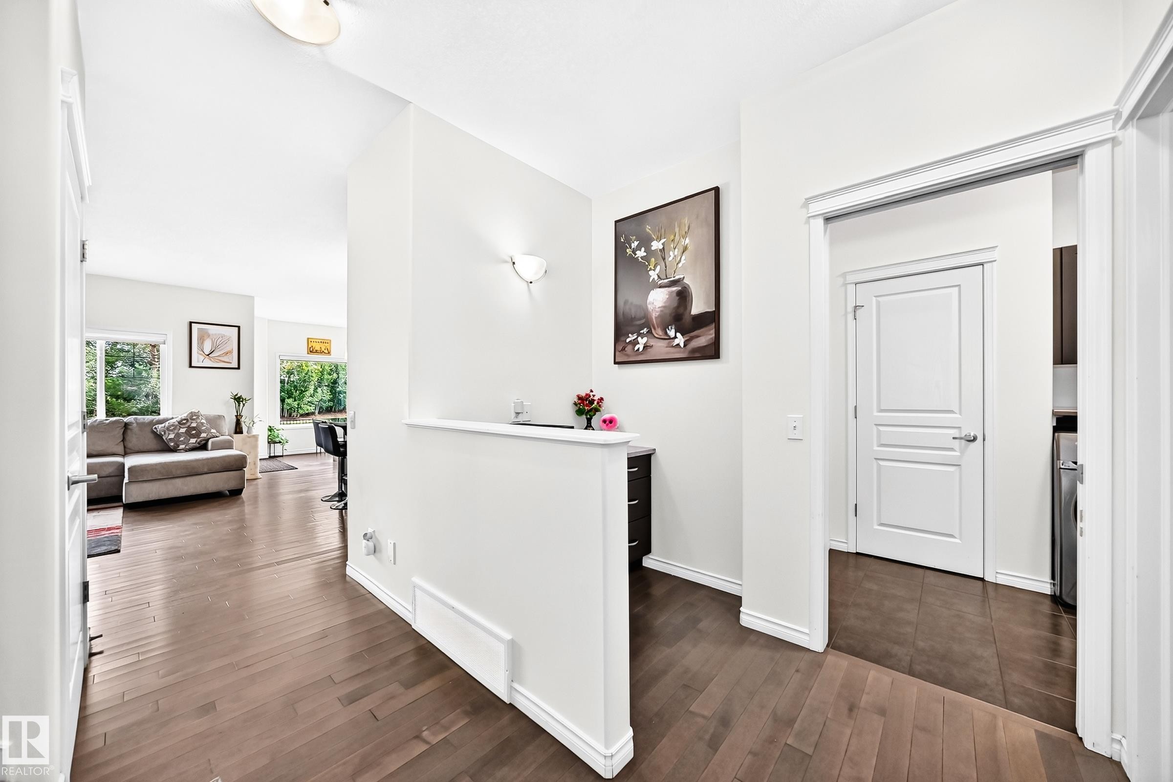 Hardwood flooring throughout, recessed lighting, and white trim accents - 2015 Chalmers Way Sw, Edmonton, AB