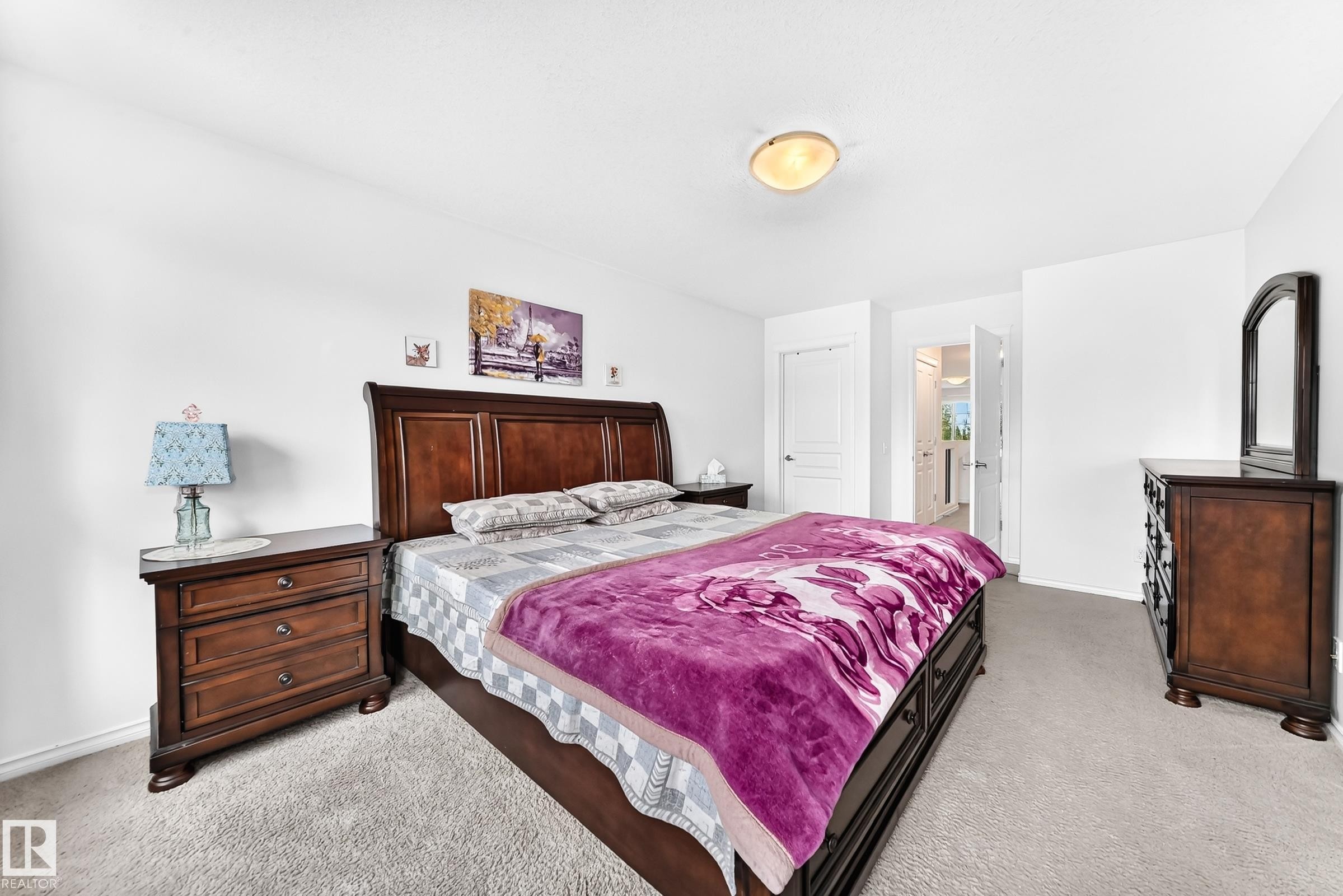 Carpeted flooring extending throughout, white painted walls, and a ceiling-mounted light fixture - 2015 Chalmers Way Sw, Edmonton, AB