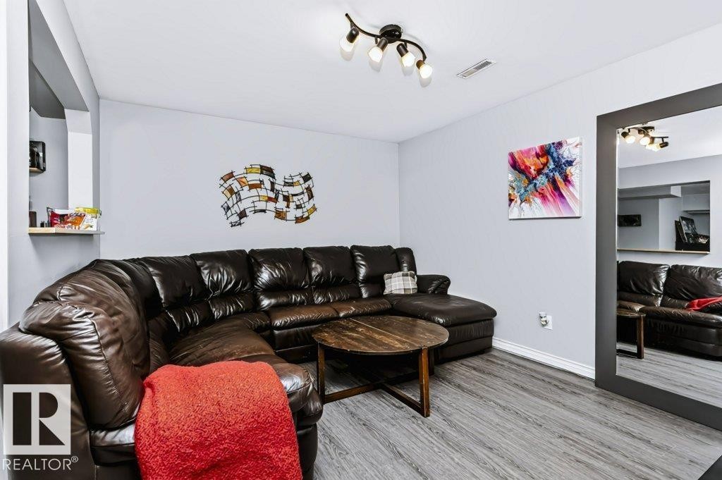 Wood-finish flooring, recessed ceiling, track lighting, and a built-in wall shelf - 18431 95A Avenue Nw, Edmonton, AB