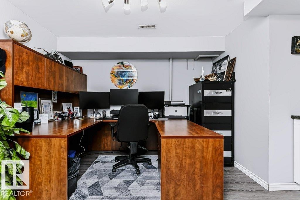 U-shaped built-in wood-finish desk with integrated upper cabinetry - 18431 95A Avenue Nw, Edmonton, AB