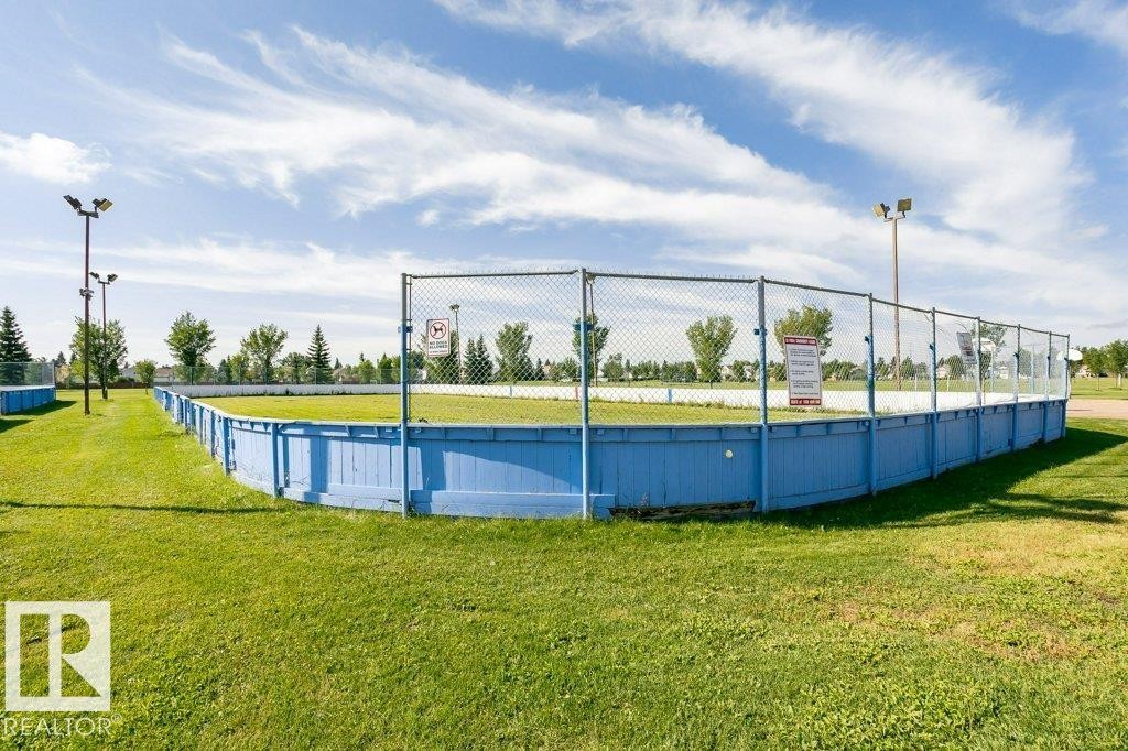 Outdoor recreational court with perimeter fencing and ground-level lighting - 18431 95A Avenue Nw, Edmonton, AB