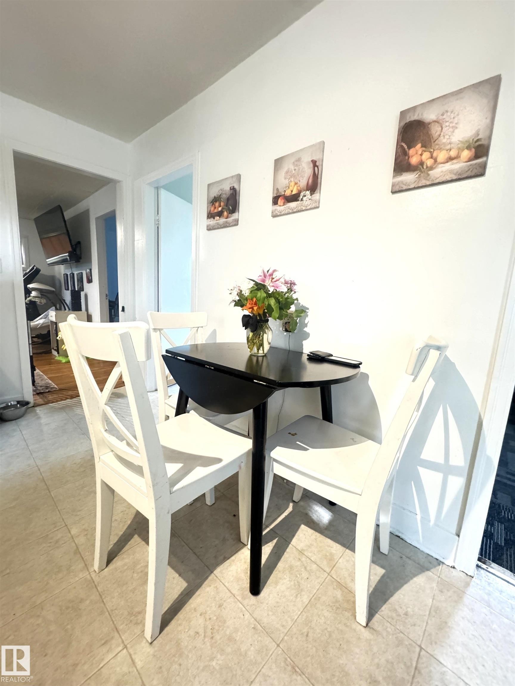 Compact dining area featuring tile flooring, white baseboards, and a bright white wall finish - 5019 48 Avenue, Onoway, AB - Indoor Photo Showing Dining Room