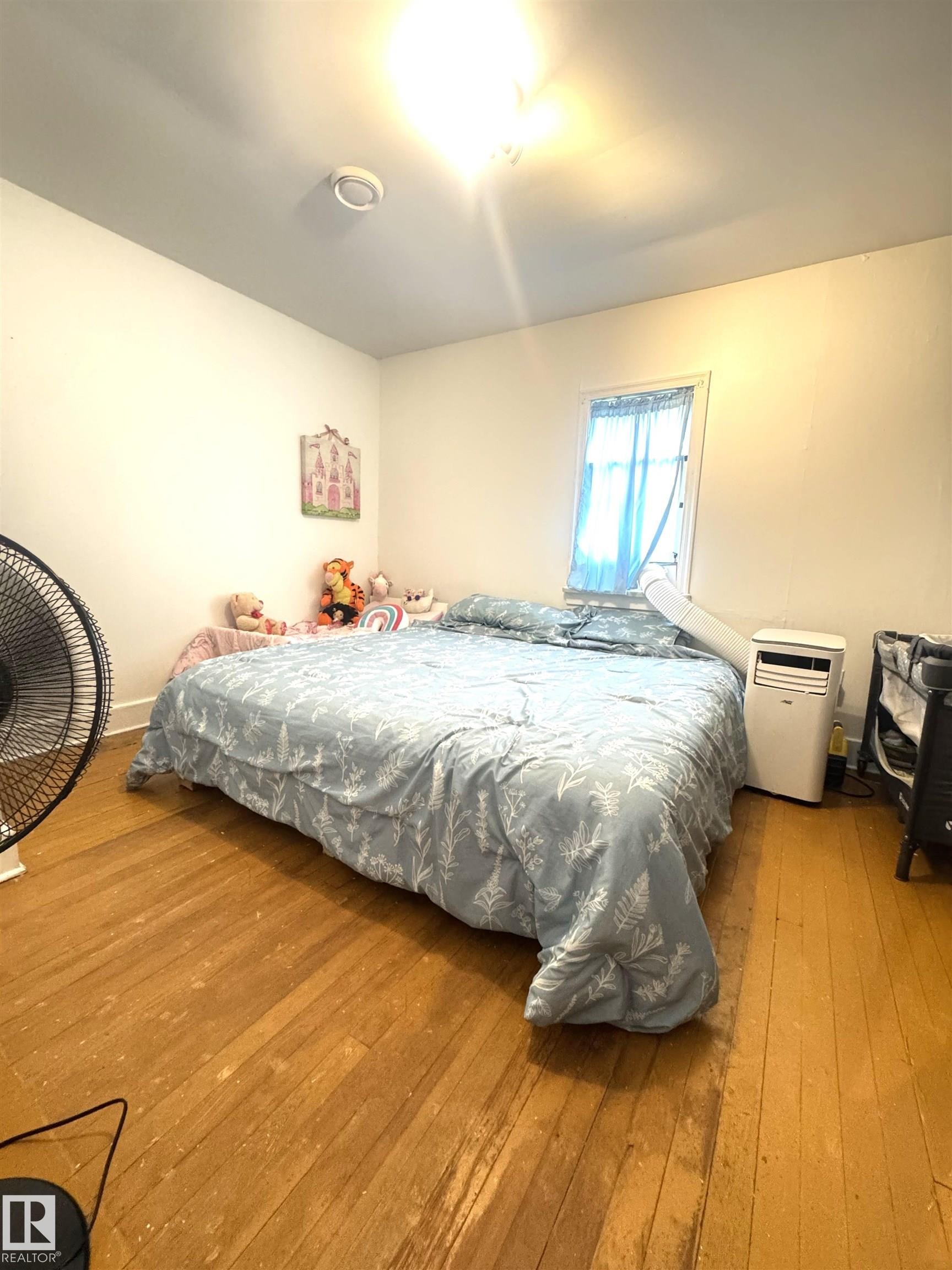 Hardwood flooring throughout - 5019 48 Avenue, Onoway, AB - Indoor Photo Showing Bedroom