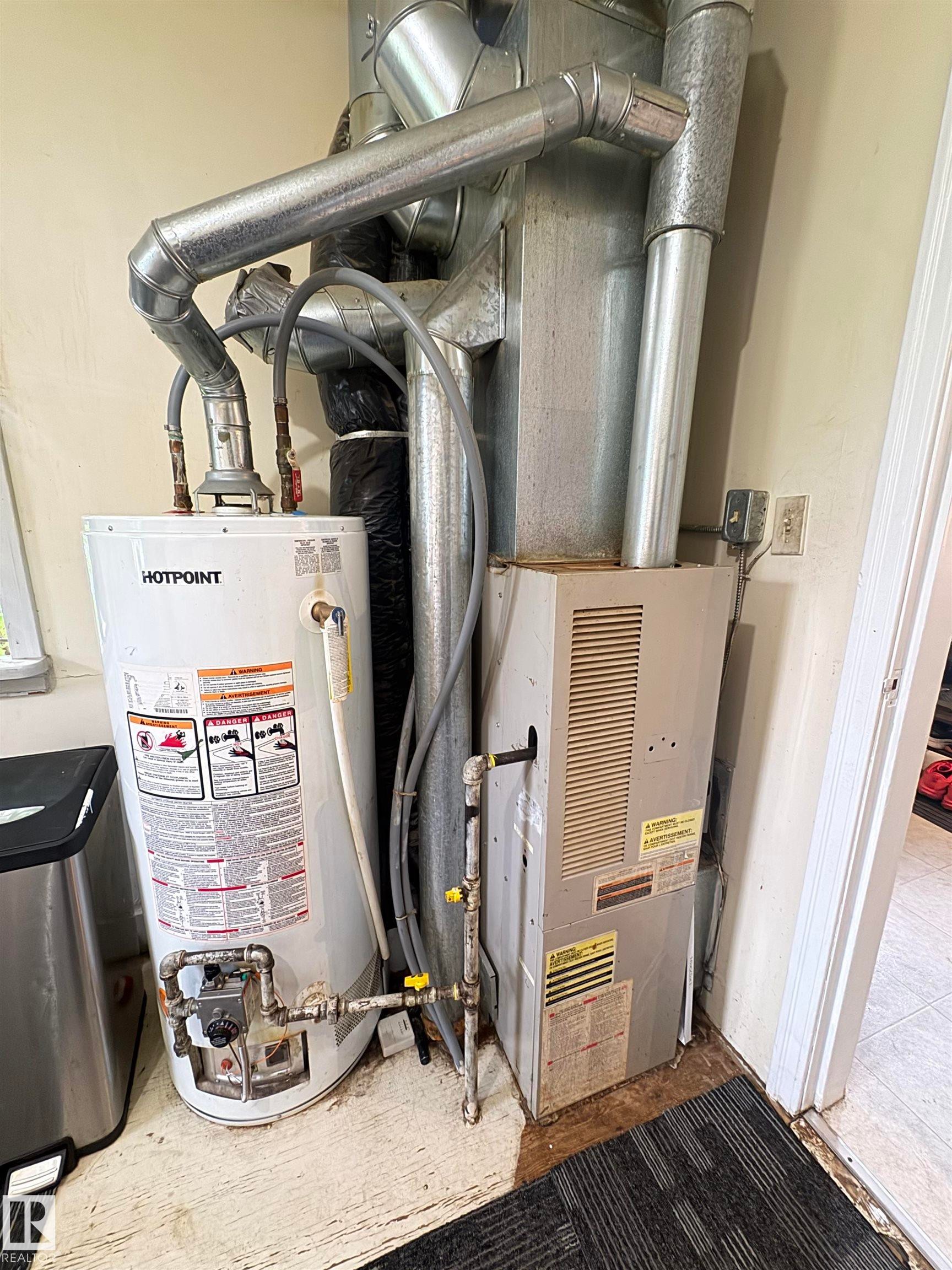 features furnace and hot water tank - 5019 48 Avenue, Onoway, AB - Indoor Photo Showing Basement