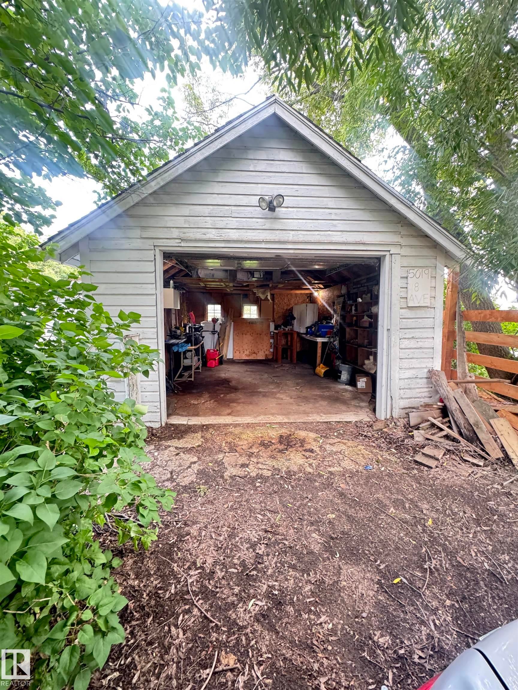Detached gable-roof garage with horizontal siding and exposed interior framing - 5019 48 Avenue, Onoway, AB - Outdoor