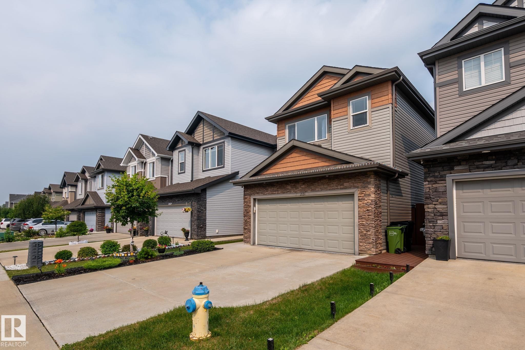 Modern two-story residence featuring a combination of siding and stone veneer - 2131 51 Sw, Edmonton, AB - Outdoor