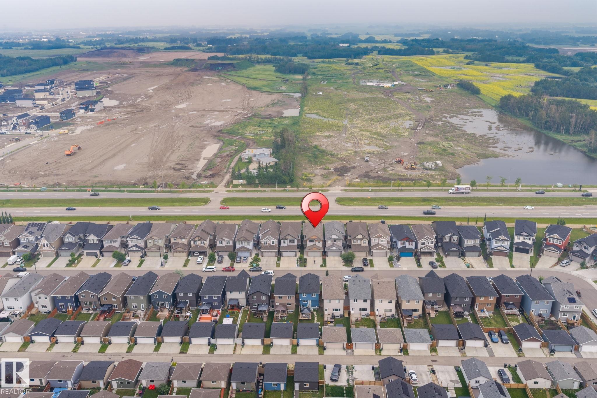 Aerial perspective of a developed residential street with rows of detached homes, featuring dark-toned roofs - 2131 51 Sw, Edmonton, AB - Outdoor With View