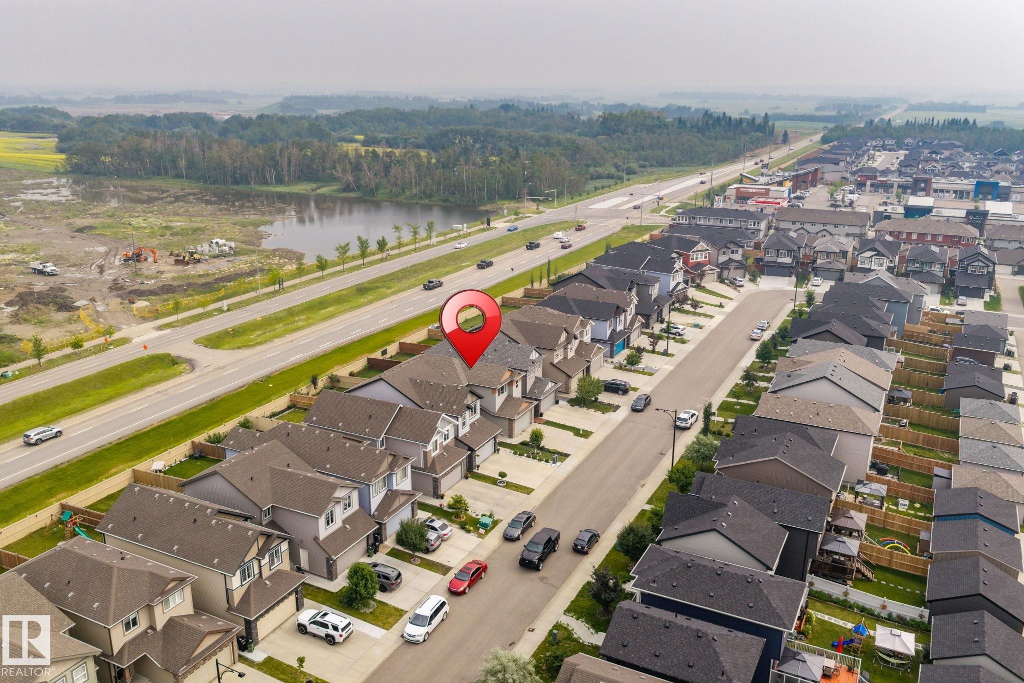 Aerial perspective showcasing a residential community with a consistent architectural style - 2131 51 Sw, Edmonton, AB - Outdoor With View