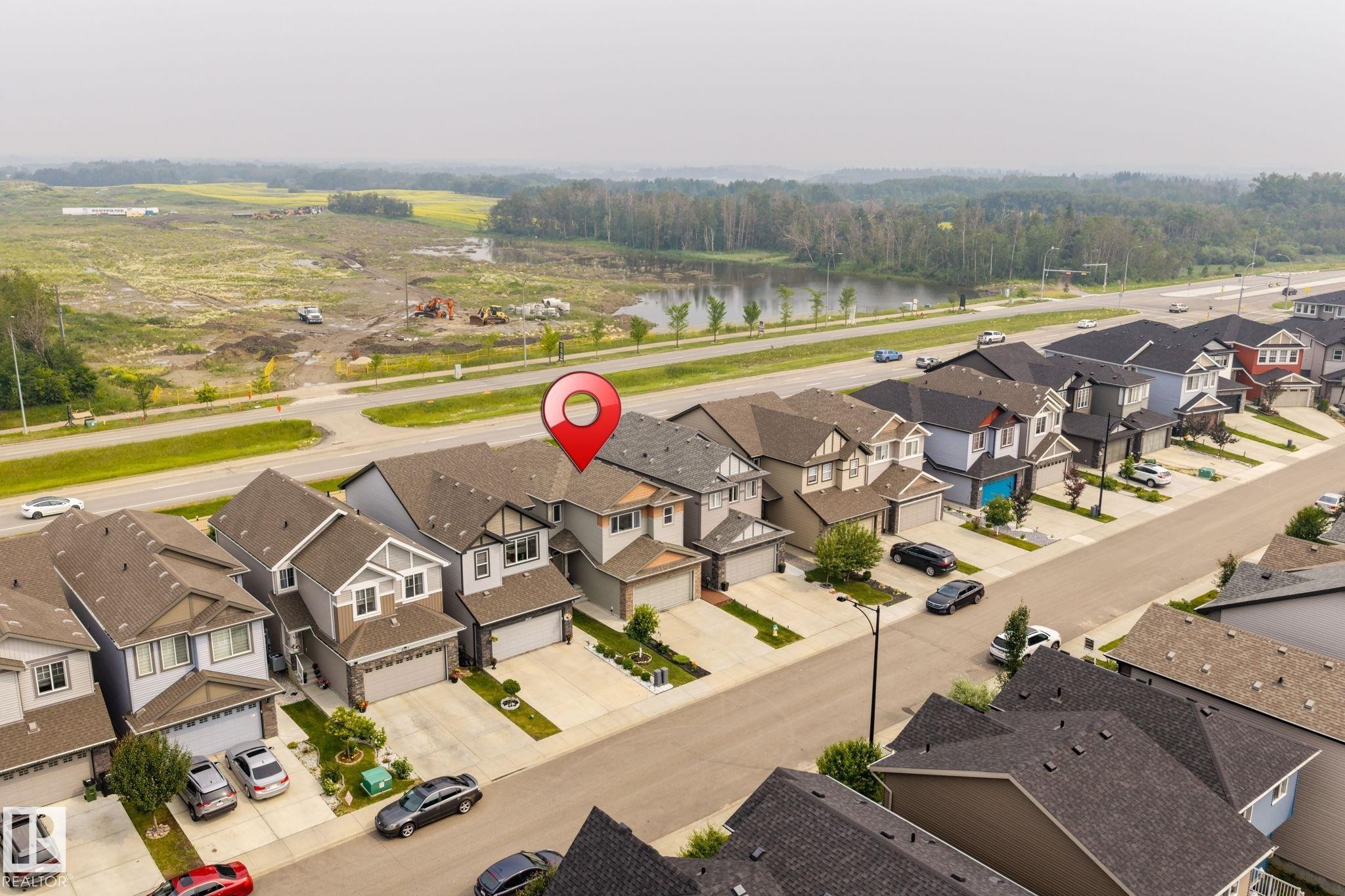 Aerial perspective showcasing a residential street with uniform contemporary homes - 2131 51 Sw, Edmonton, AB - Outdoor With View