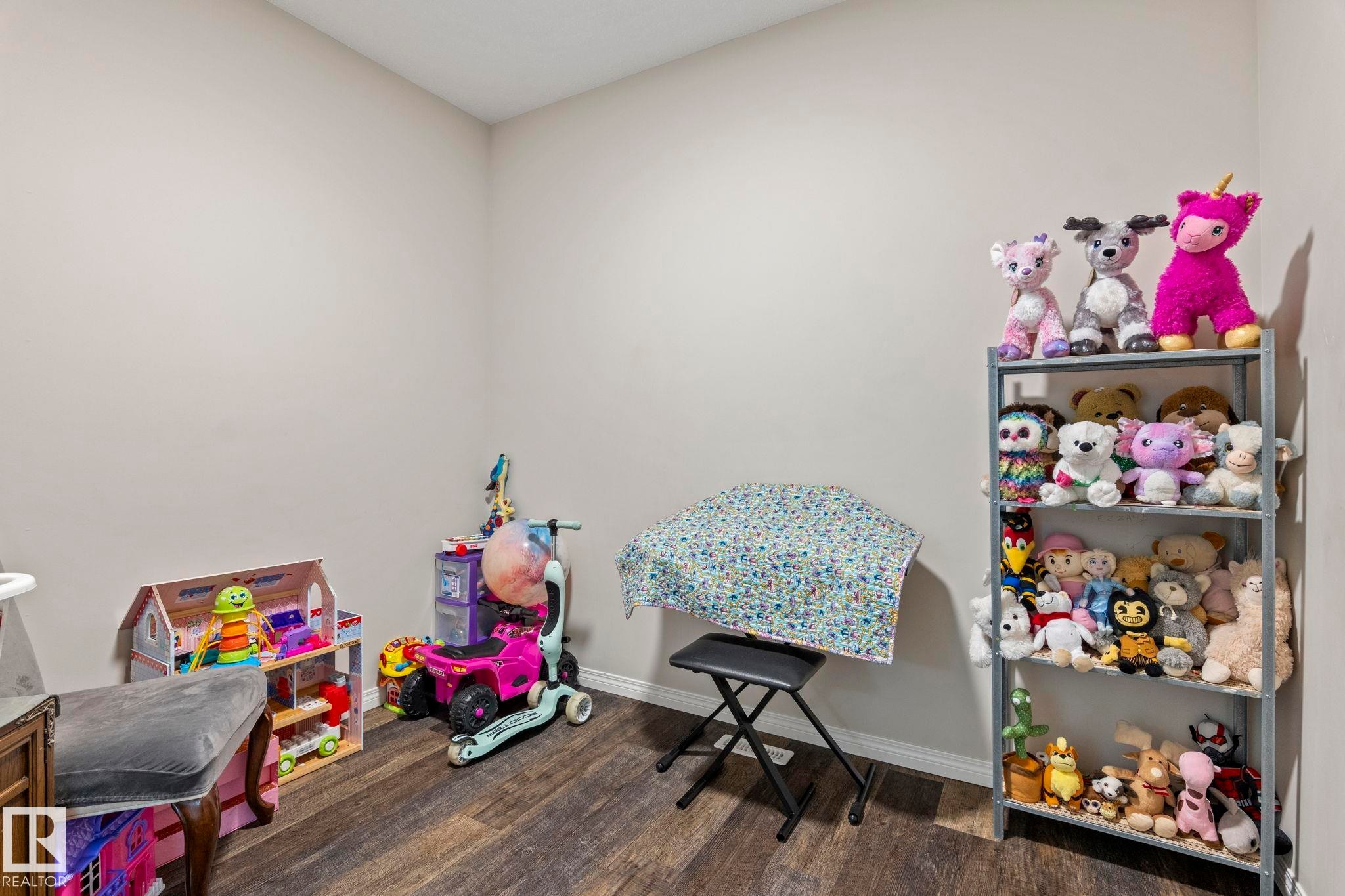 Interior room featuring neutral wall paint and wood-finish flooring - 2131 51 Sw, Edmonton, AB - Indoor Photo Showing Other Room