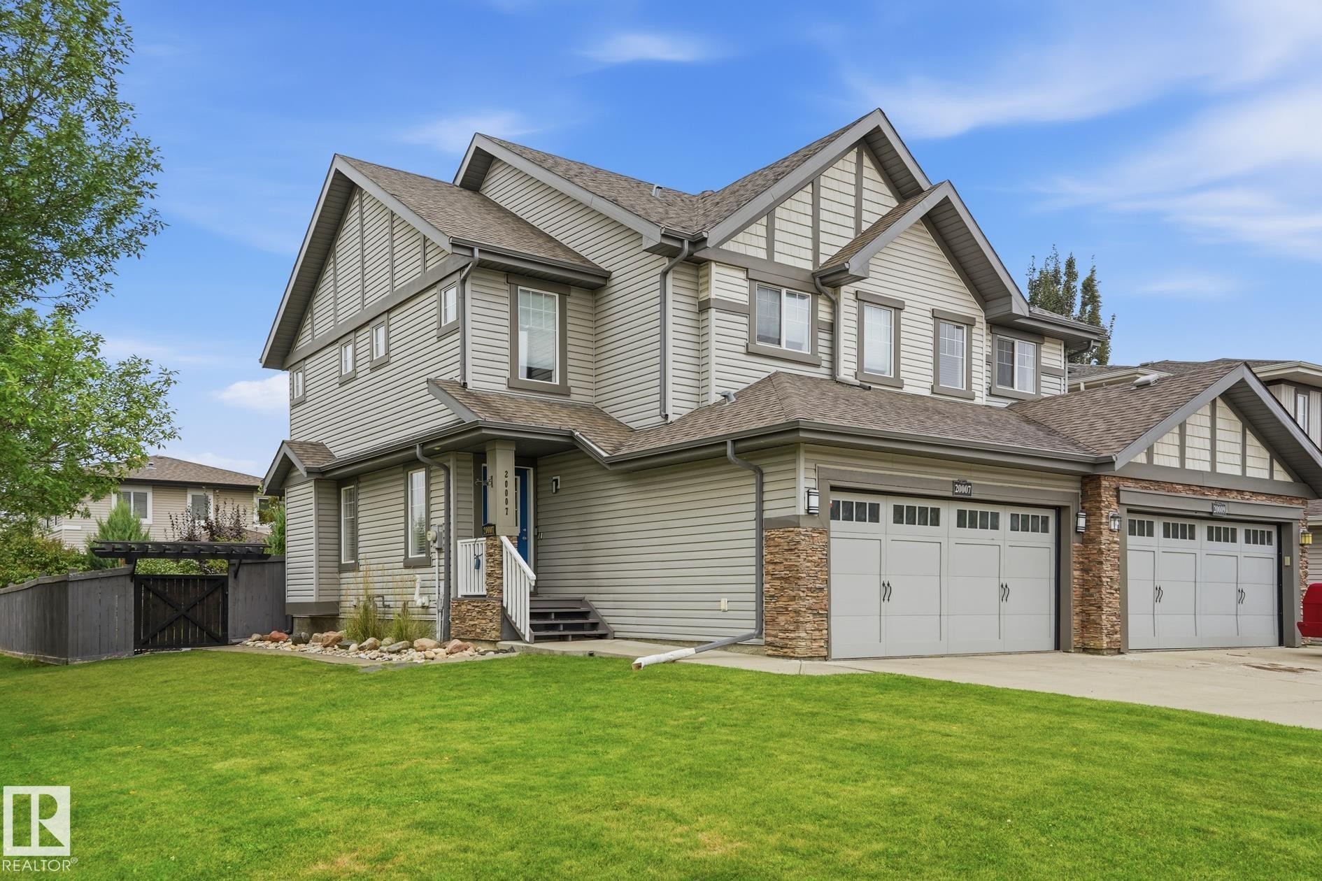 Multi-level facade with stone accents and horizontal siding - 20007 131 Avenue Nw, Edmonton, AB