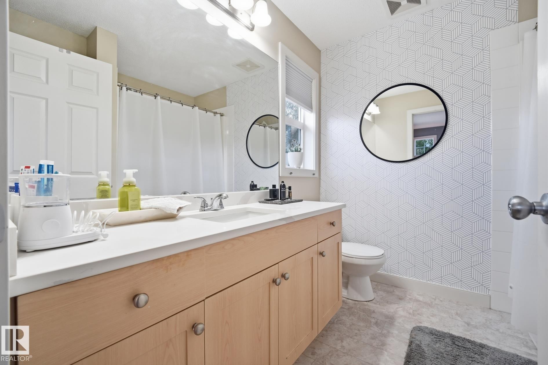 Single vanity with light wood-finish cabinetry and a light-toned countertop - 20007 131 Avenue Nw, Edmonton, AB