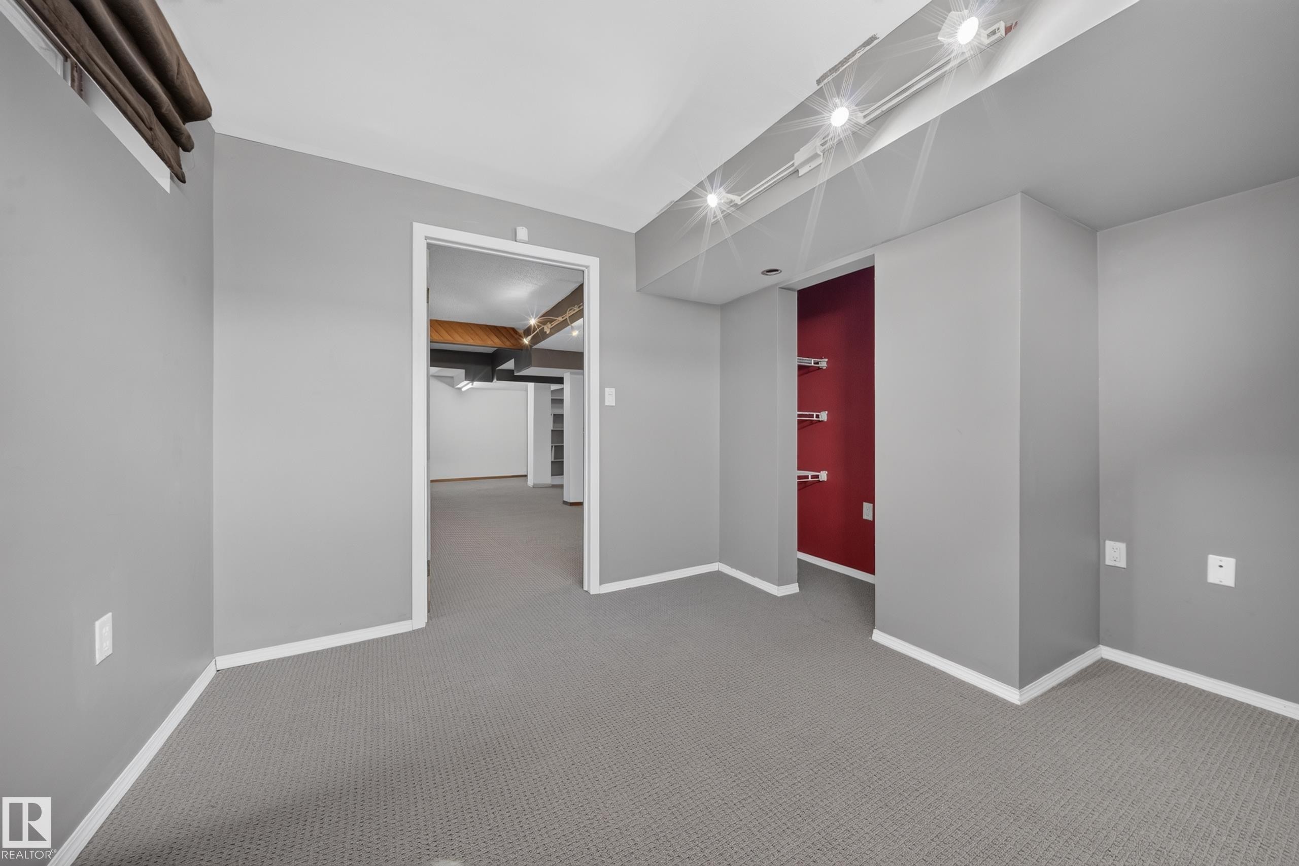 Grey carpet flooring, track lighting, neutral wall tones, and recessed shelving - 155 Marlborough Place Nw, Edmonton, AB