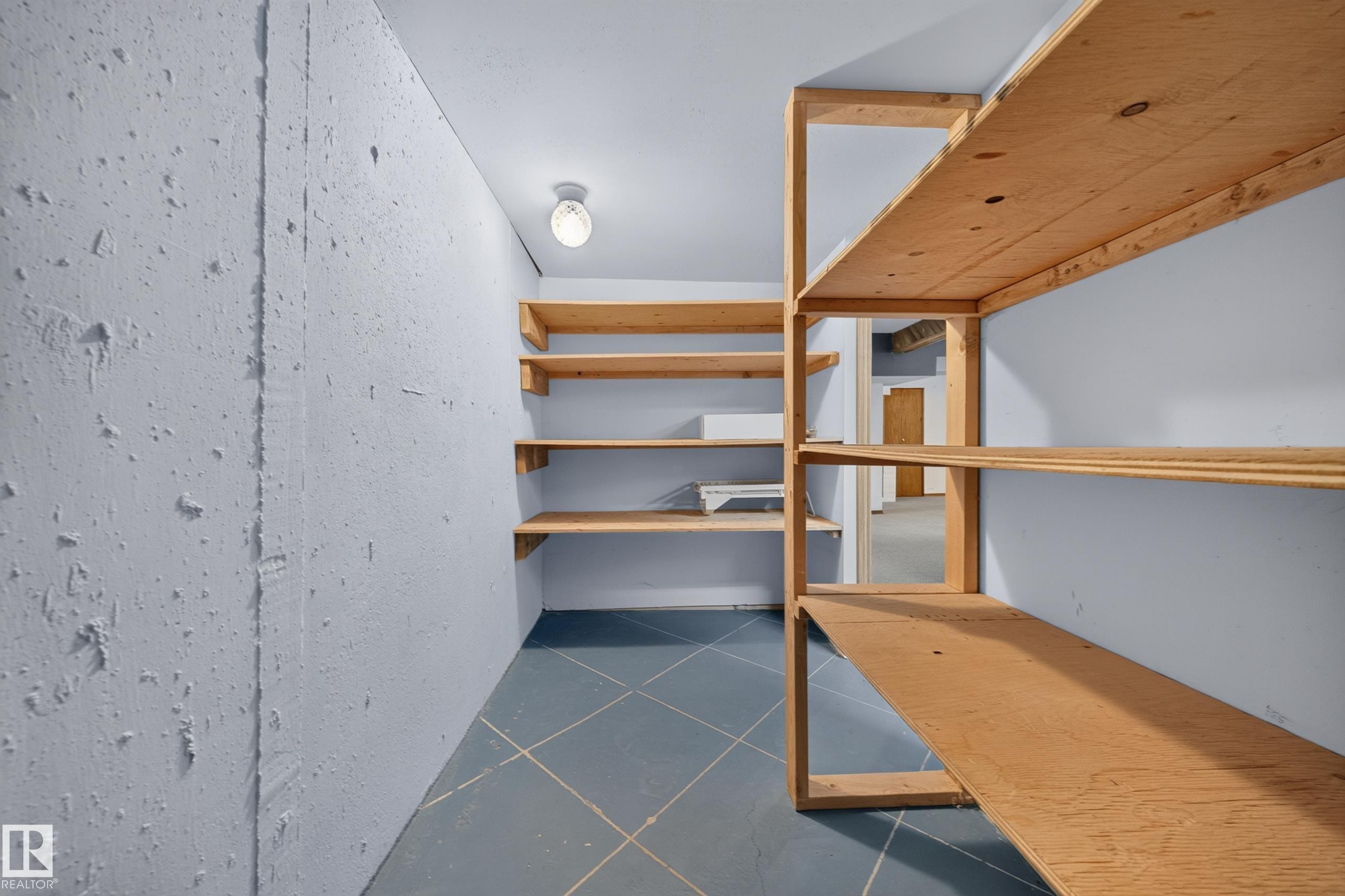 Built-in wood shelving units, recessed ceiling light fixture, and textured wall finish - 155 Marlborough Place Nw, Edmonton, AB