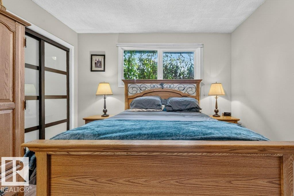 Wood-finish flooring throughout - 11131 35A Avenue Nw, Edmonton, AB - Indoor Photo Showing Bedroom